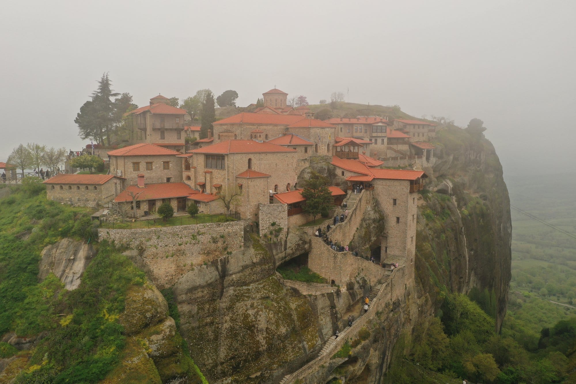 Aerial shot of Meteora's rocks lit by afternoon sun — Kalambaka, Greece