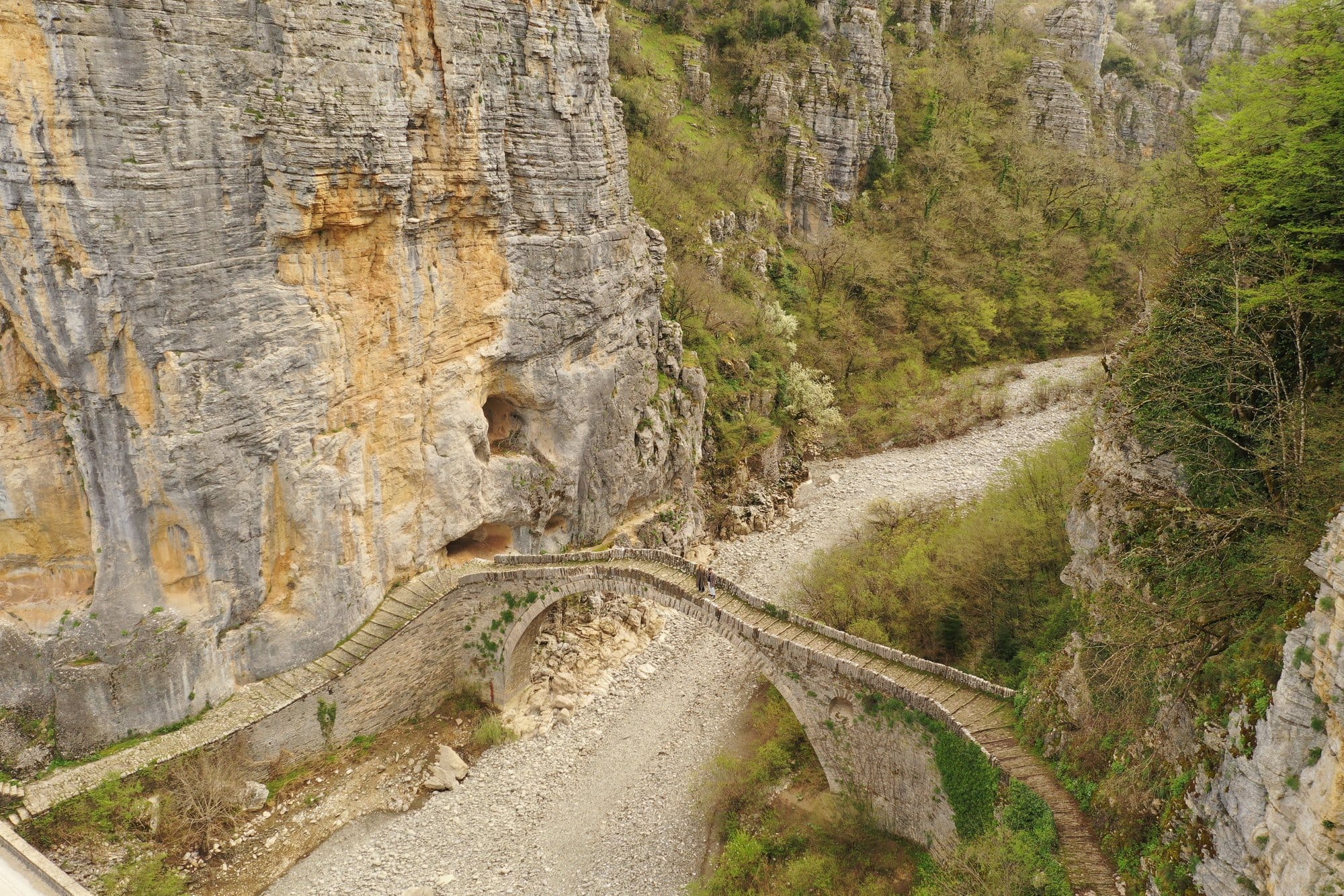 Old stone arch bridge crossing a narrow Zagori canyon — Greece