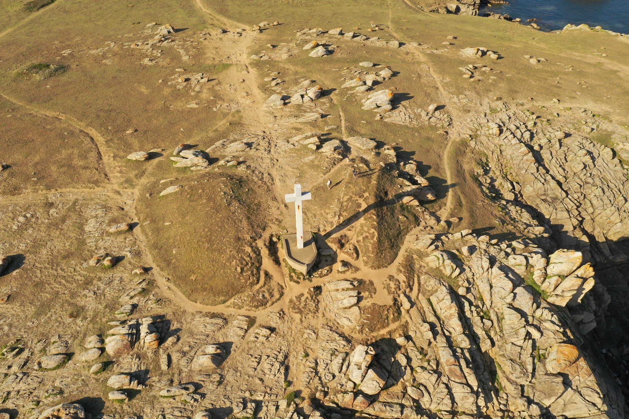 Aerial view of the white memorial cross at the Pointe de la Tranche, the island's westernmost point, captured with a DJI Mavic Pro 2 — Île d'Yeu, France
