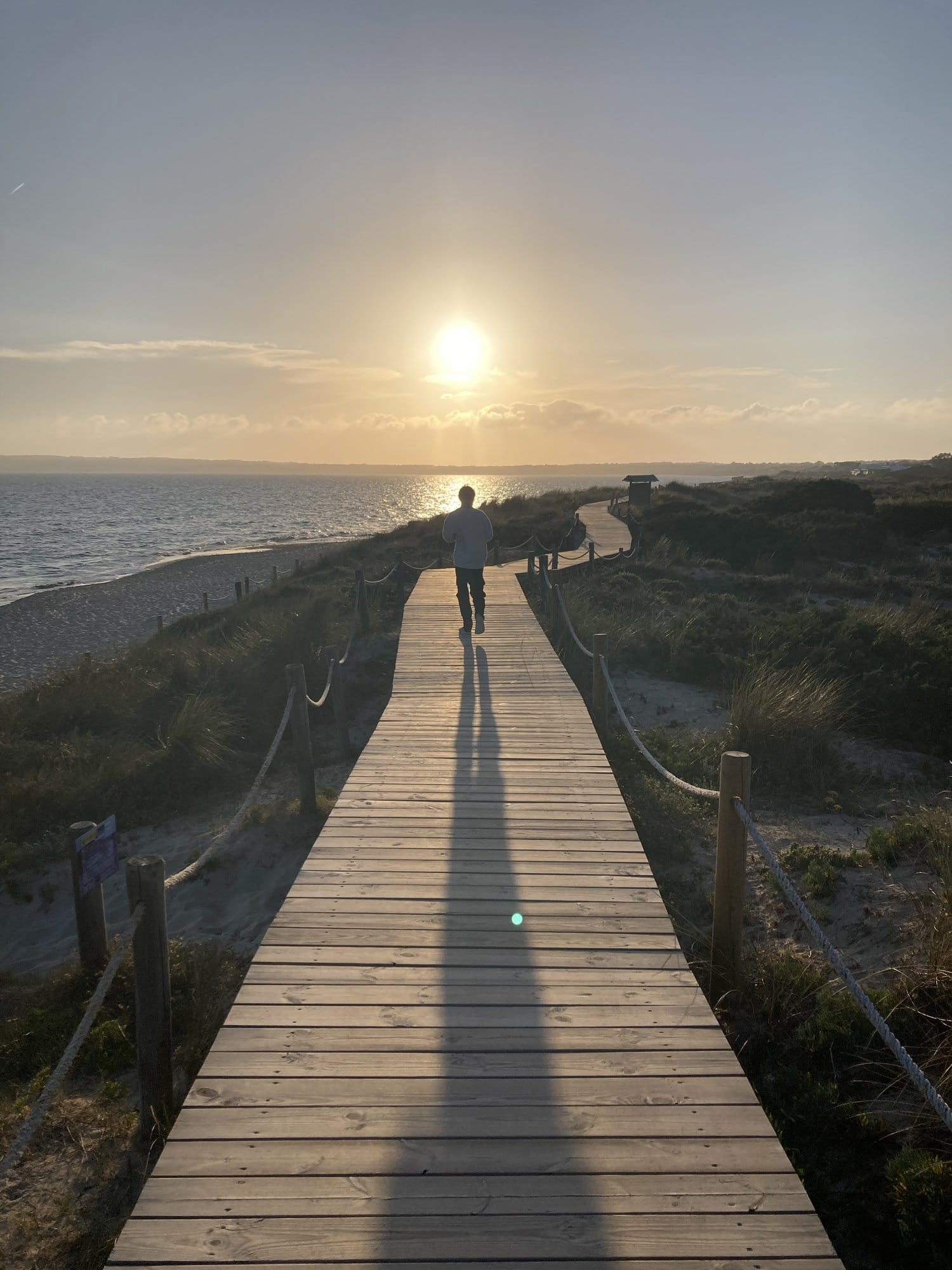 Wooden boardwalk to beach golden hour — Formentera, Spain