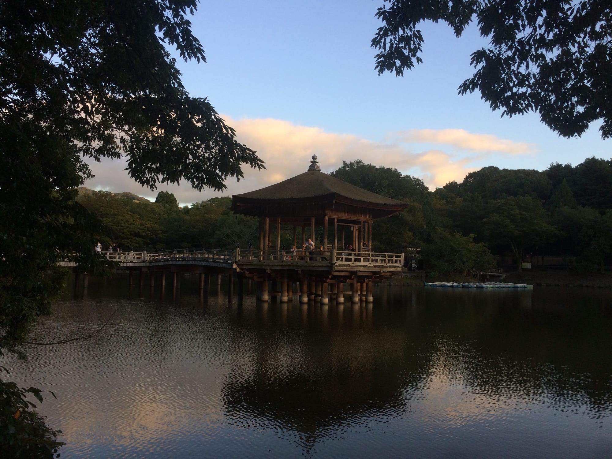 The Ukimido floating pavilion mirrored in Sagiike Pond under golden-hour sky — Nara Park, Japan