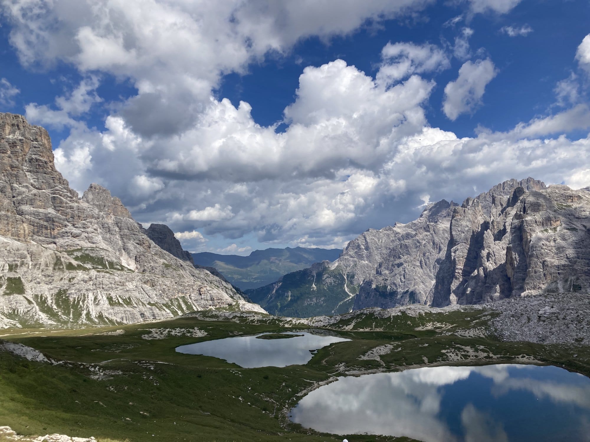 Laghi dei Piani with perfect mountain reflections and green alpine meadows — Dolomites, Italy