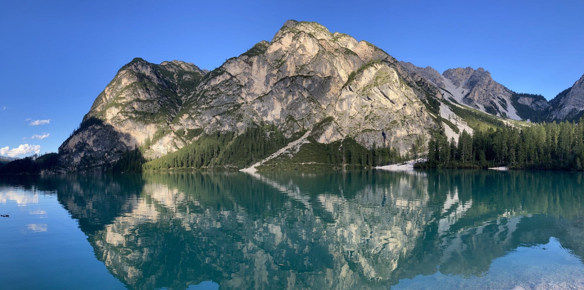 Perfect mountain reflection in the turquoise waters of Lago di Braies โ Dolomites, Italy