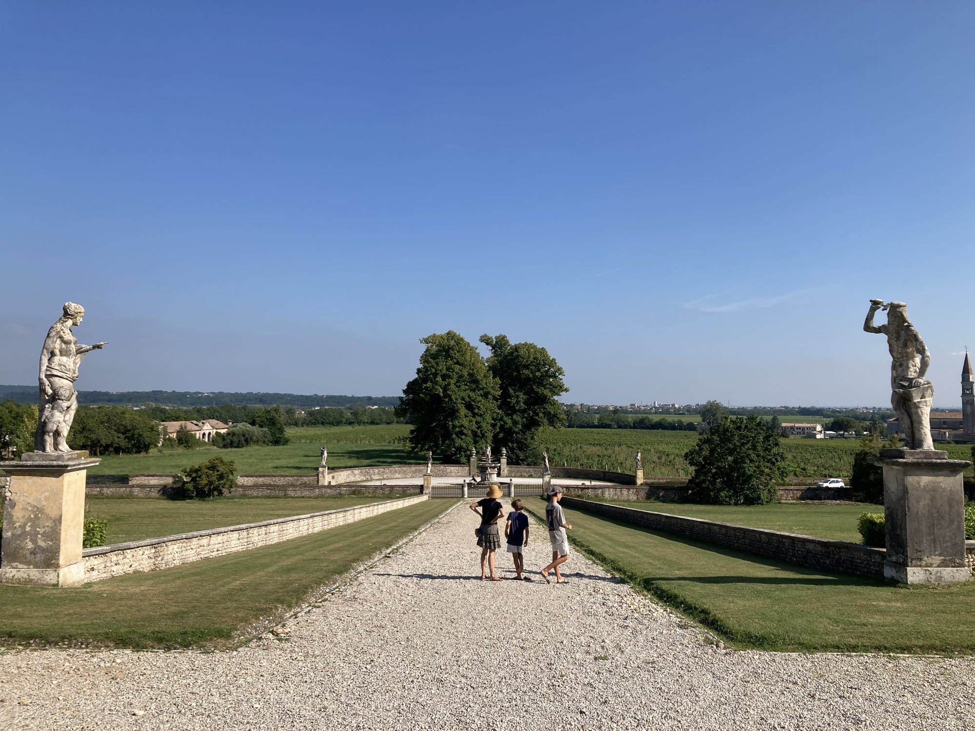 Garden allée of Villa Barbaro with classical statues and countryside views — Maser, Italy