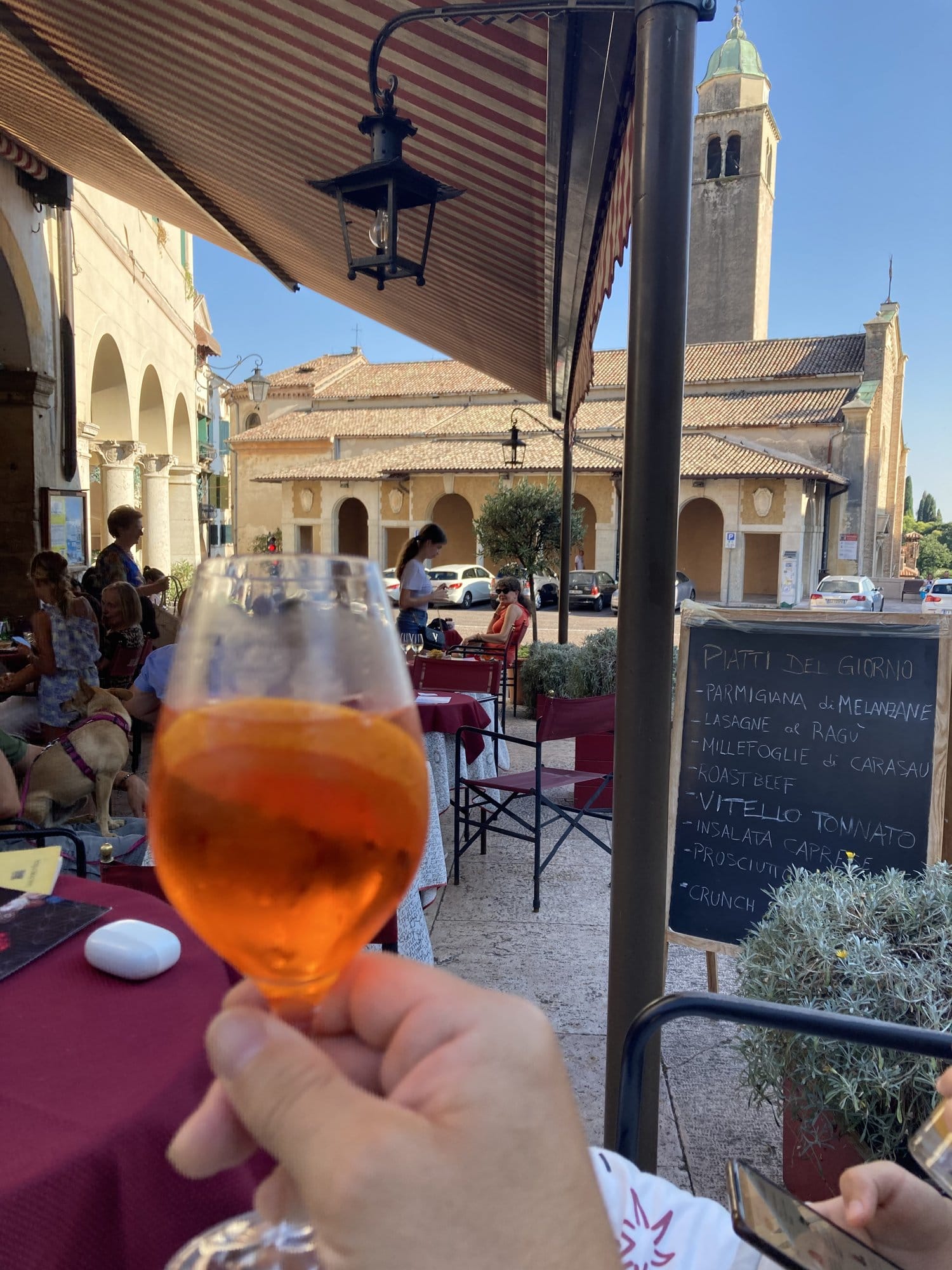 Aperol Spritz on a terrace with the campanile of Asolo in the background — Asolo, Italy