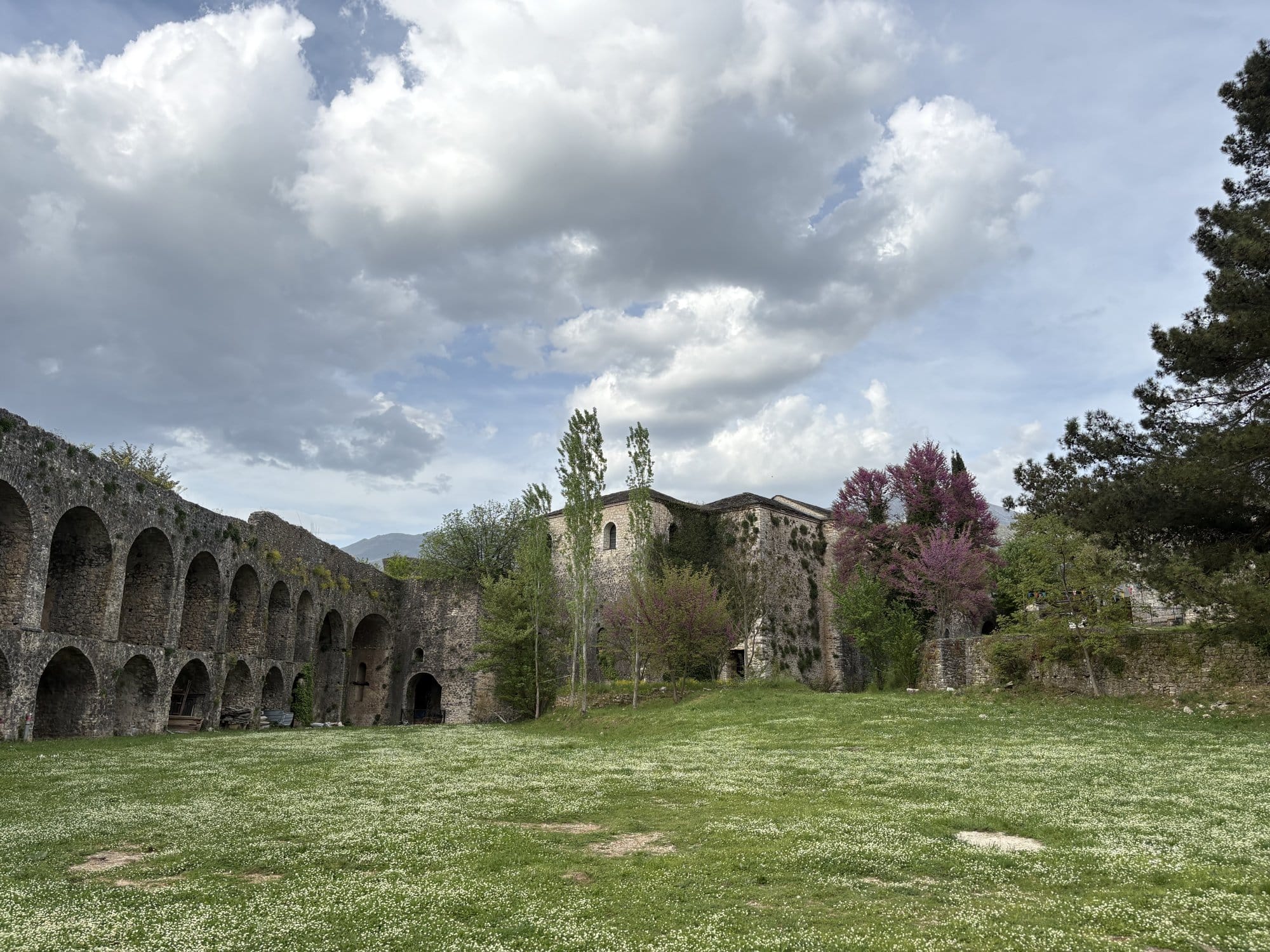 Ruines en pierre avec arches et herbes sous un ciel nuageux — près d'Ioannina, Grèce