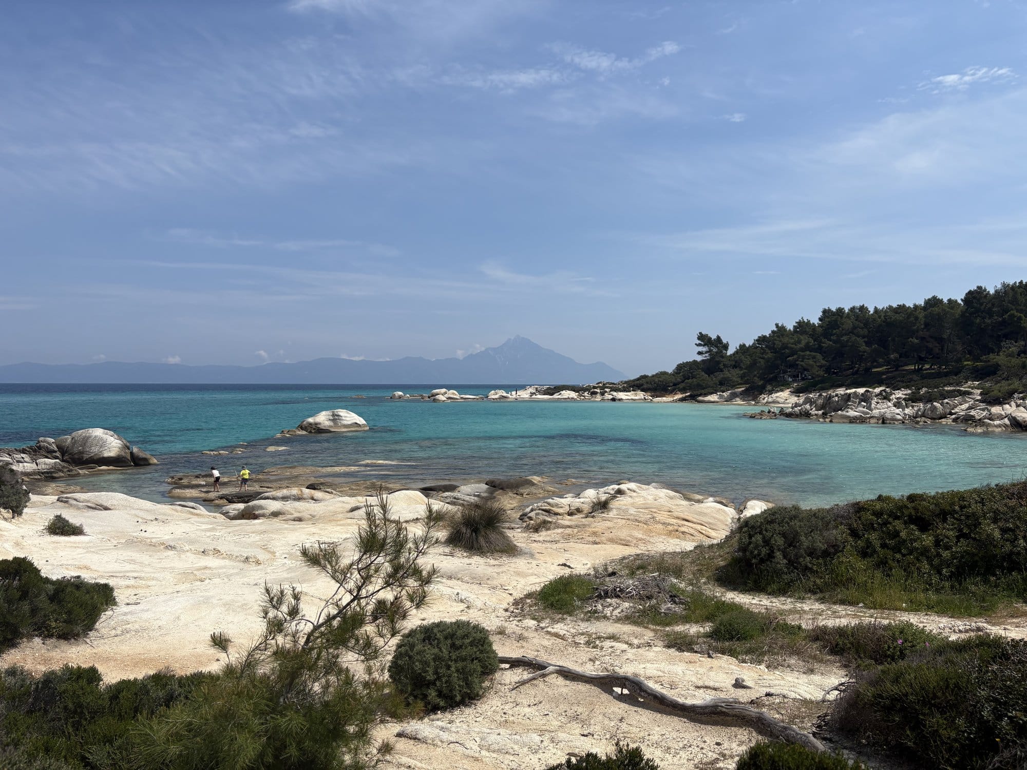 Small turquoise cove with a lone swimmer at Orange Beach (Kavourotrypes) — Sithonia, Greece