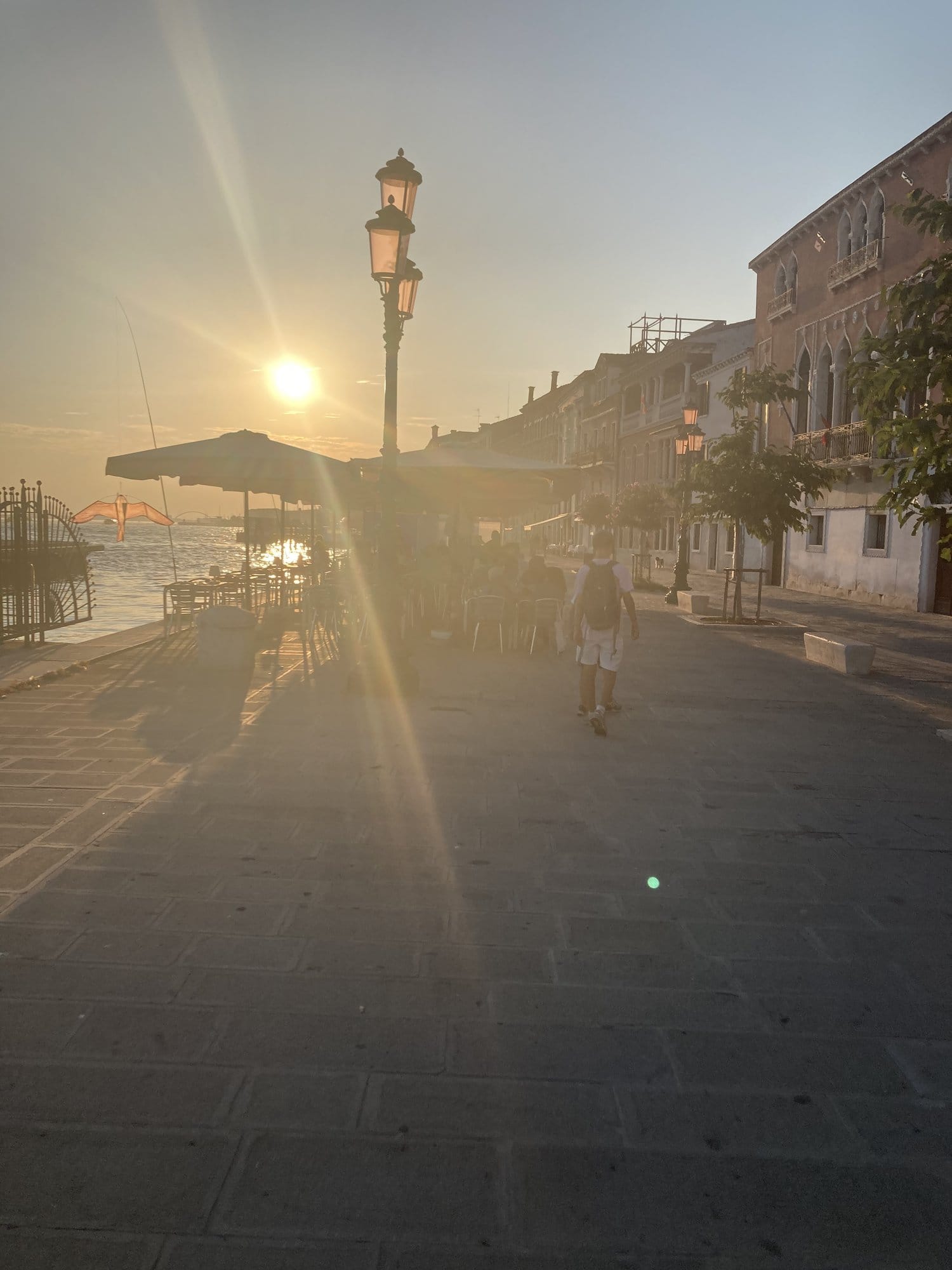 Zattere promenade at sunset with retro lampposts and golden reflections — Venice, Italy