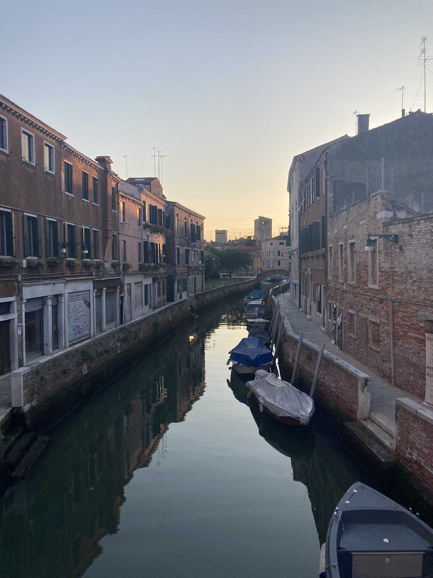Dorsoduro canal at dusk with perfect reflections and moored boats — Venice, Italy