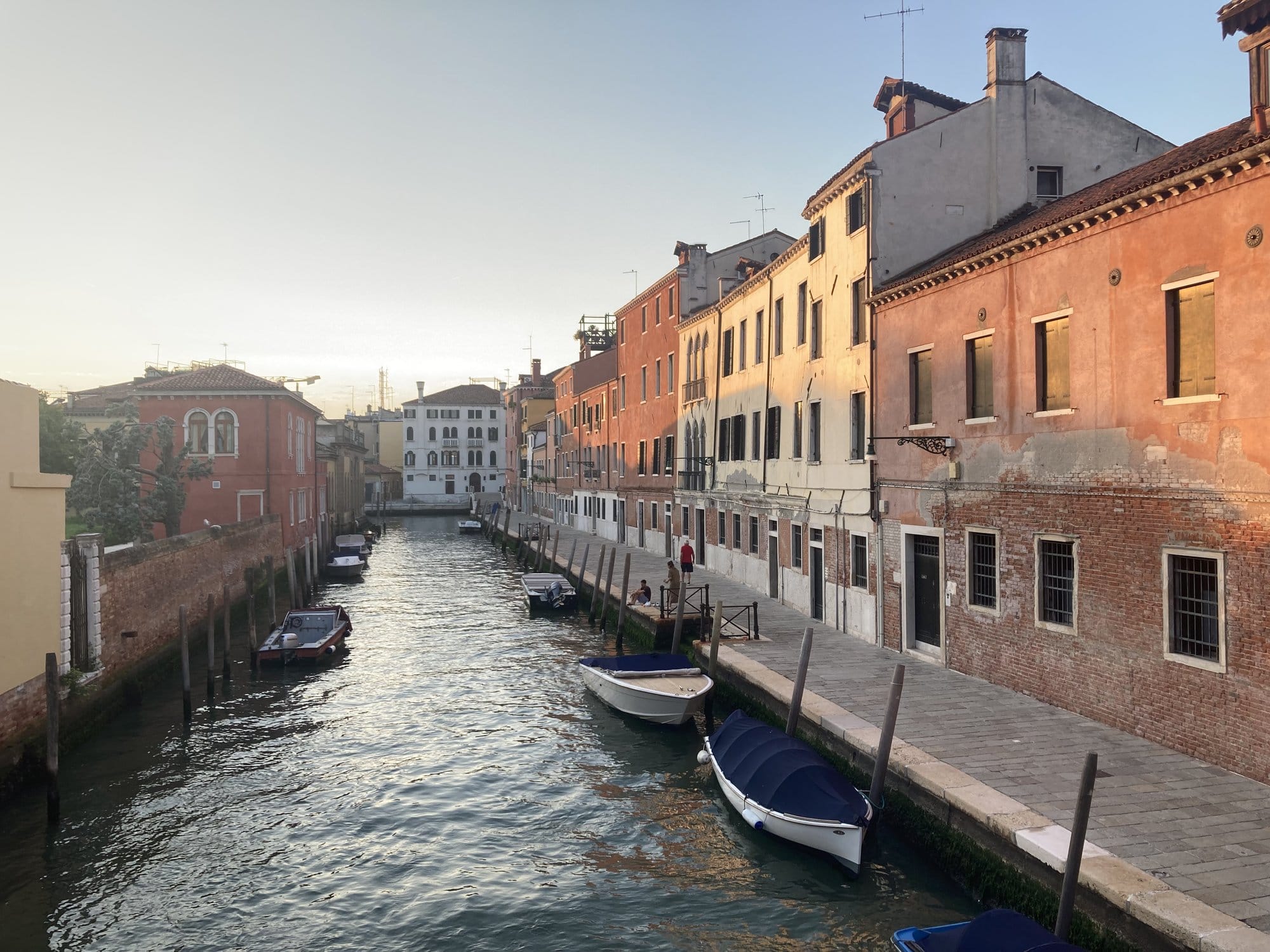 Dorsoduro canal at golden hour with ochre and pink facades — Venice, Italy