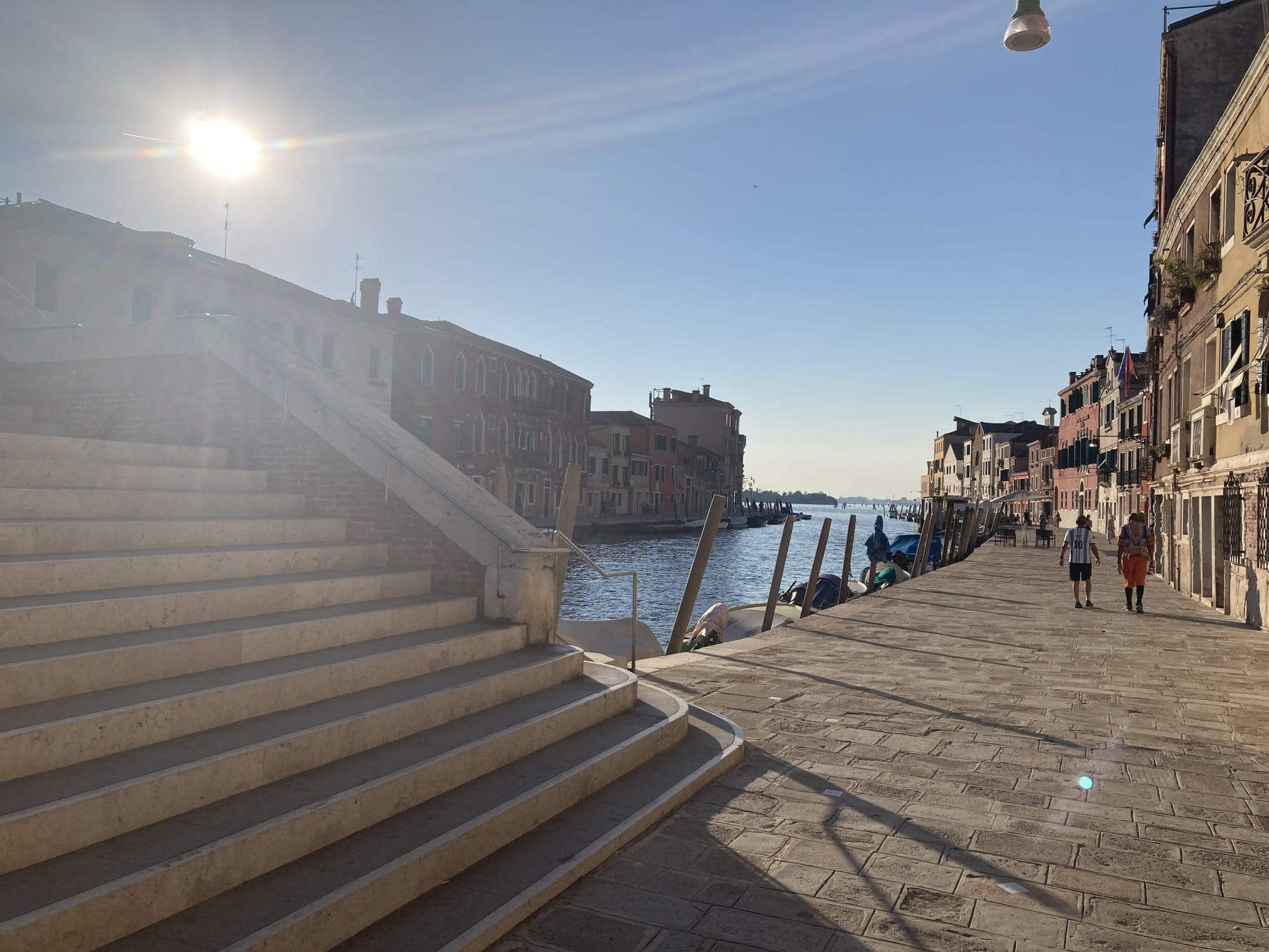 Bridge steps overlooking a canal at sunset in Cannaregio — Venice, Italy