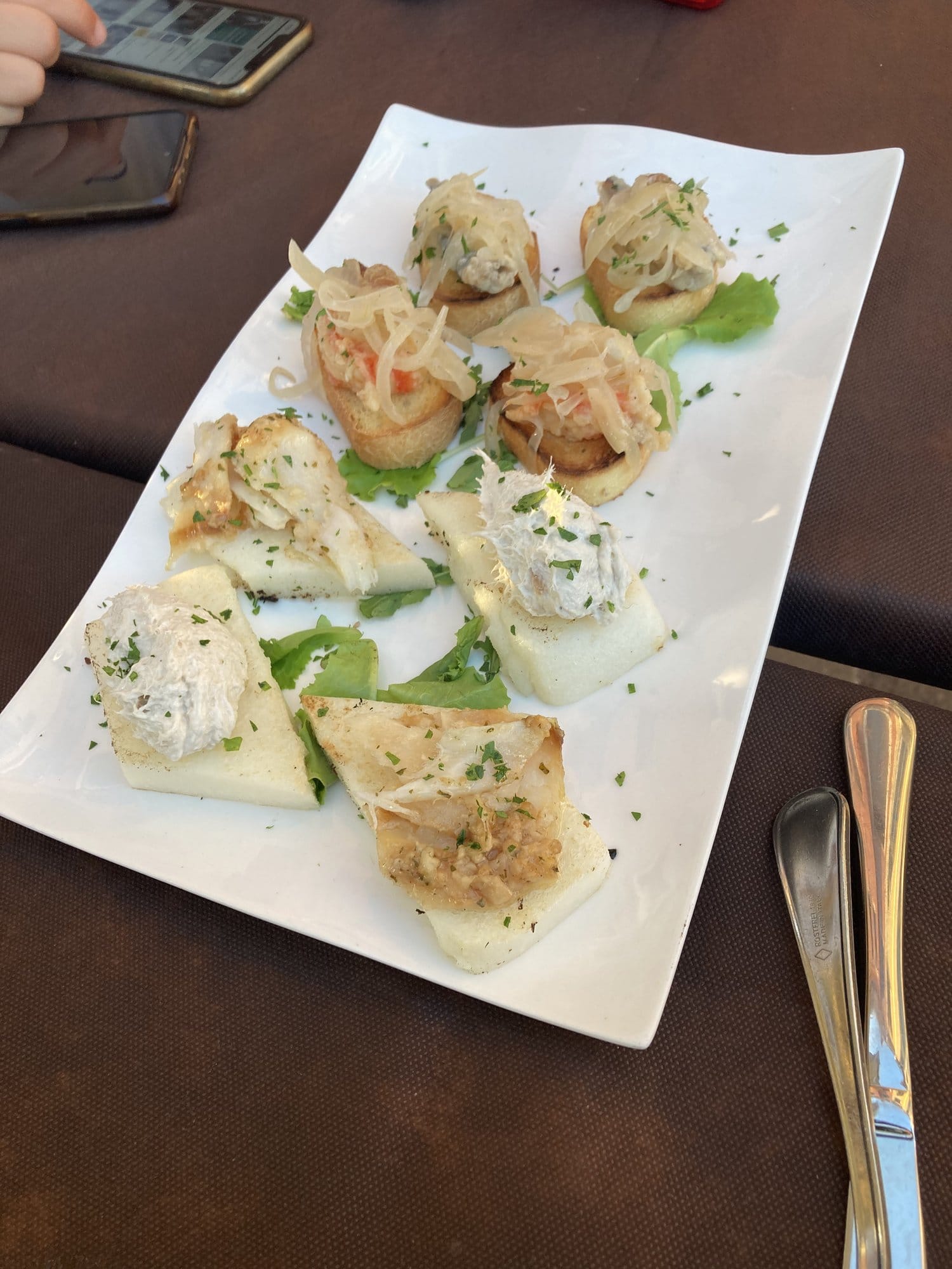 Plate of Venetian cicchetti — crostini with crab, cheese and seafood — Venice, Italy
