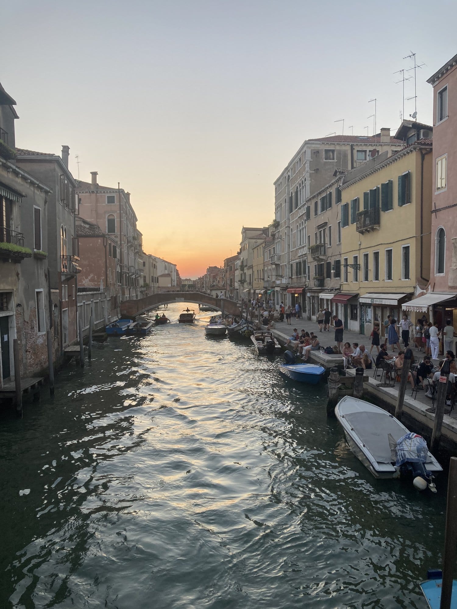 Cannaregio canal at sunset with golden reflections and bridges — Venice, Italy