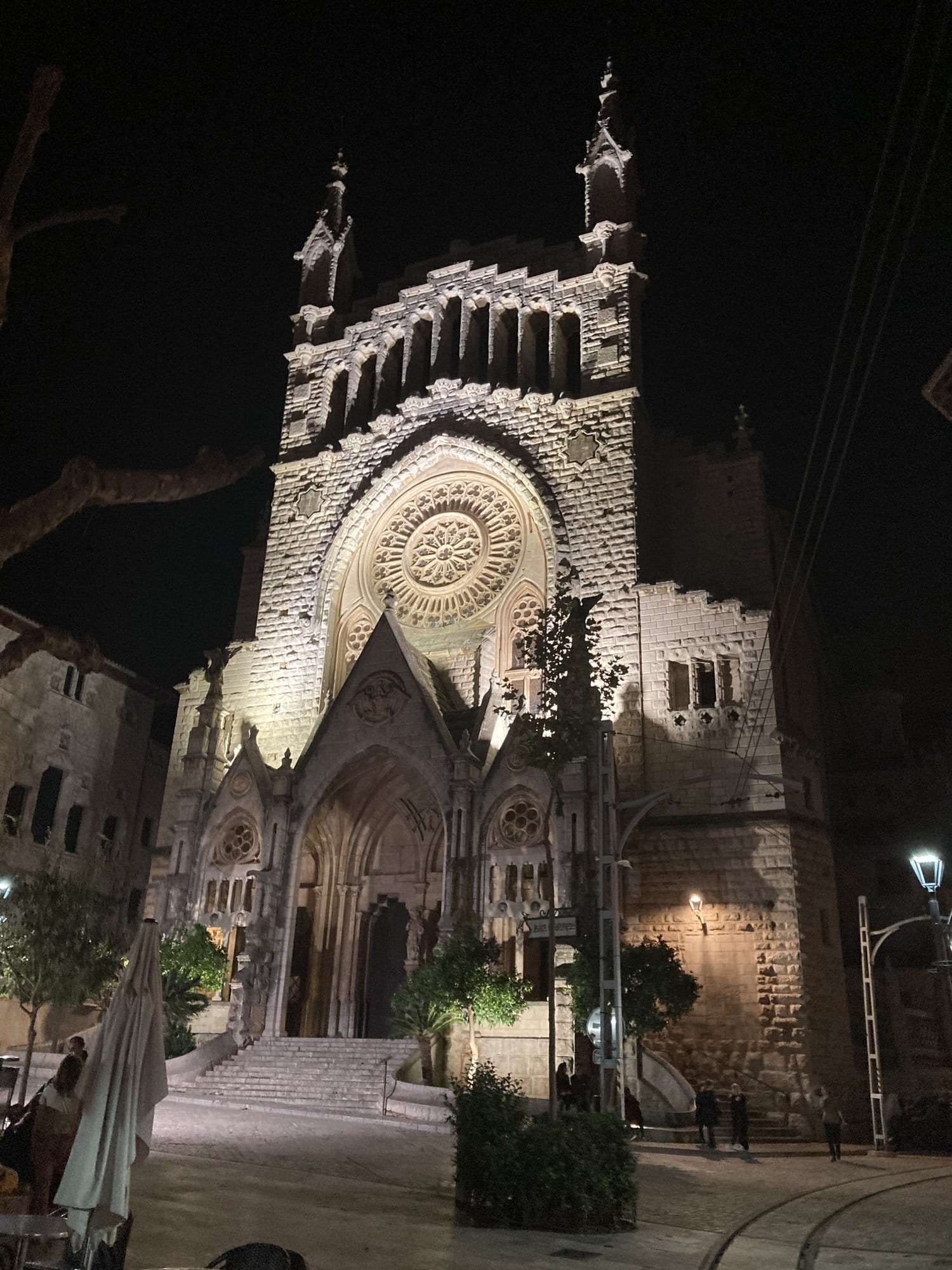 The church bell tower and dome lit against twilight — Deià, Spain