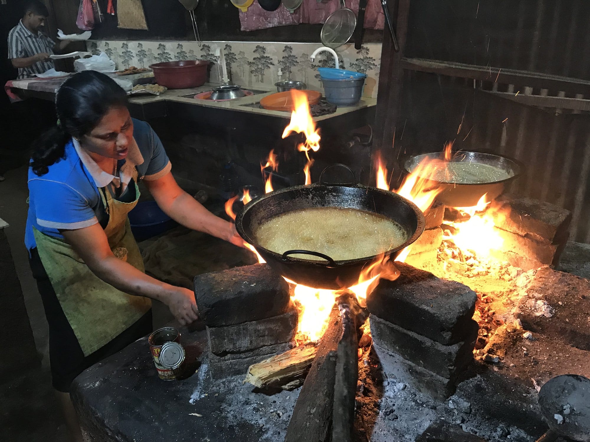 Ancient brick ruins dotted across earthen mounds with scattered tourists exploring the vast medieval site — Polonnaruwa, Sri Lanka