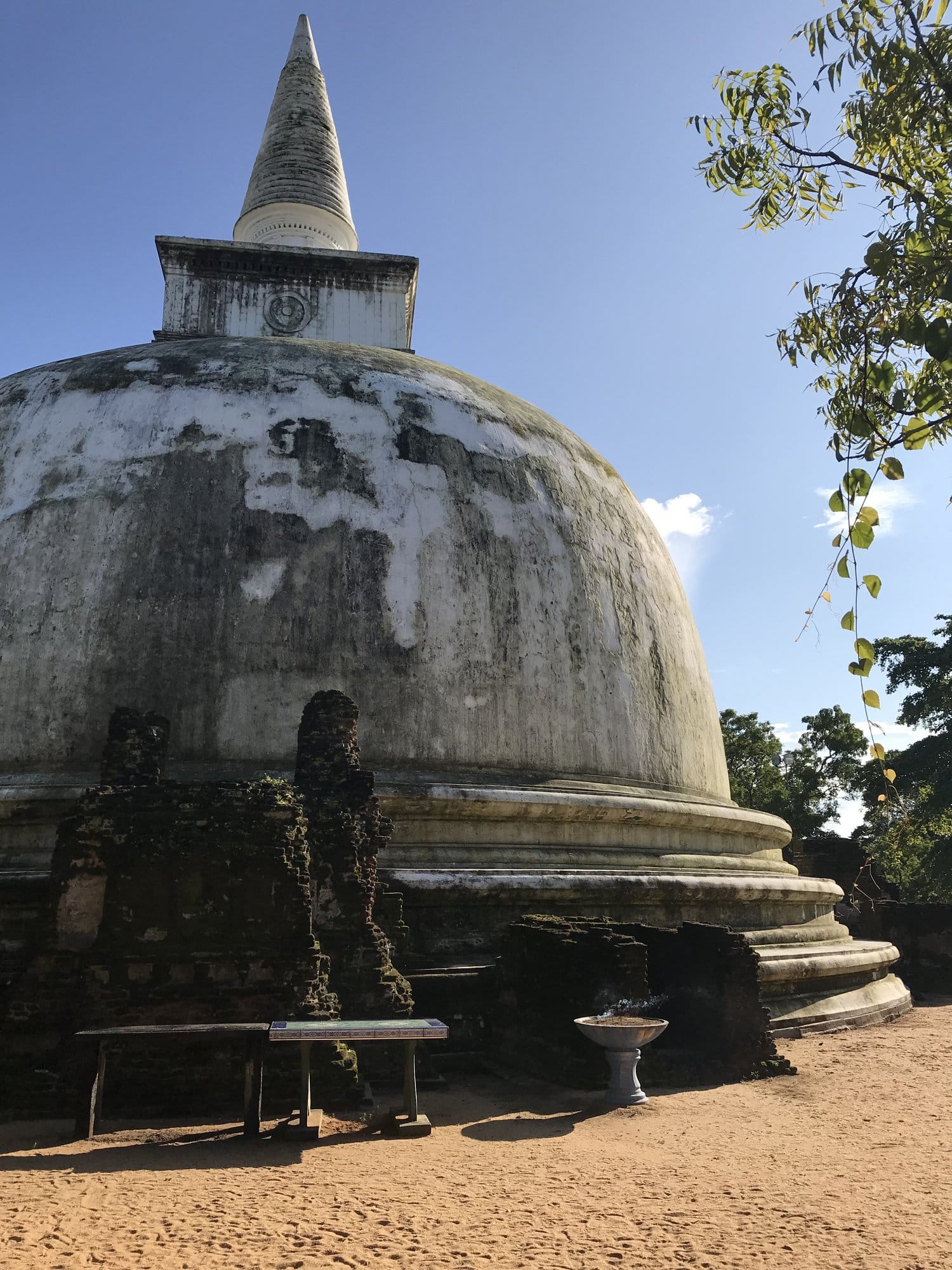 A seated Buddha in meditation posture, carved from grey stone, the figure emanating calm and spiritual presence — Polonnaruwa, Sri Lanka