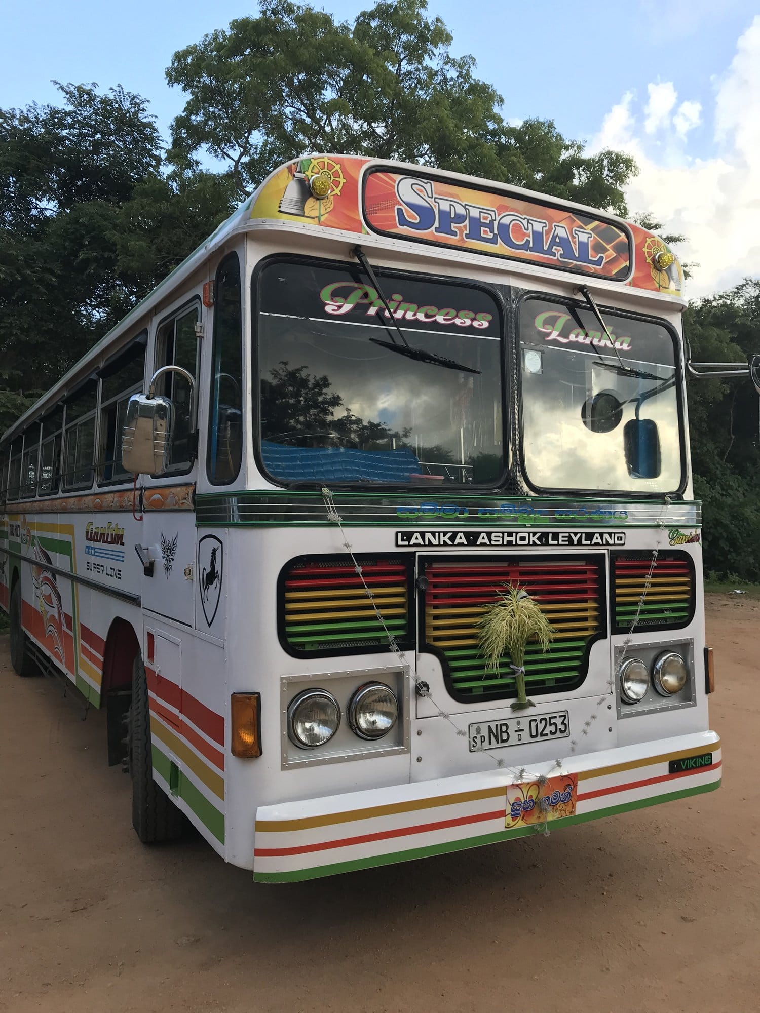 A standing Buddha with crossed arms, its posture dignified and watchful, stone details weathered but commanding — Polonnaruwa, Sri Lanka
