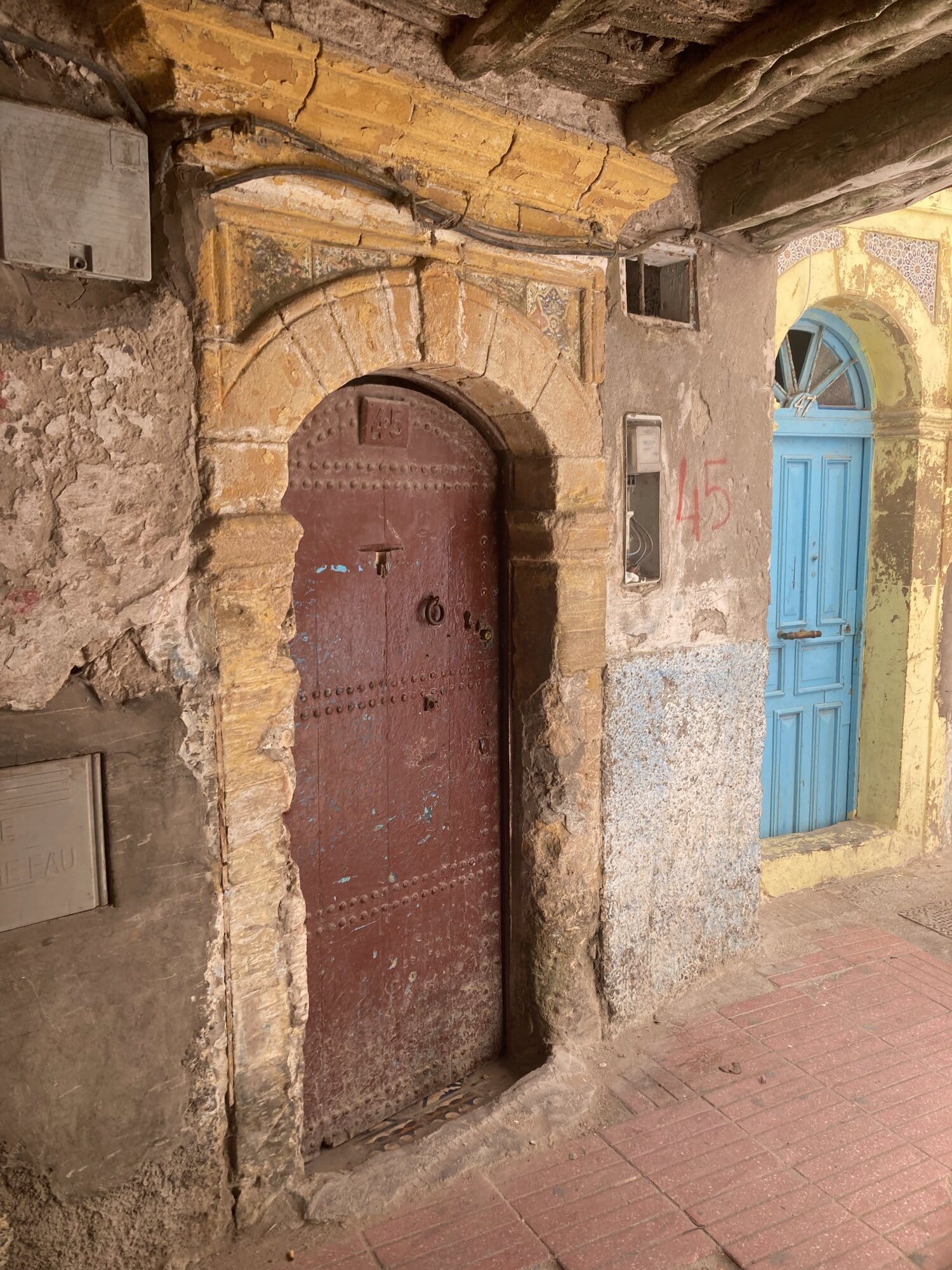 The bivouac camp the night the yoga retreat ends — Berber tents and a fire at the water's edge — coast near Essaouira, Morocco