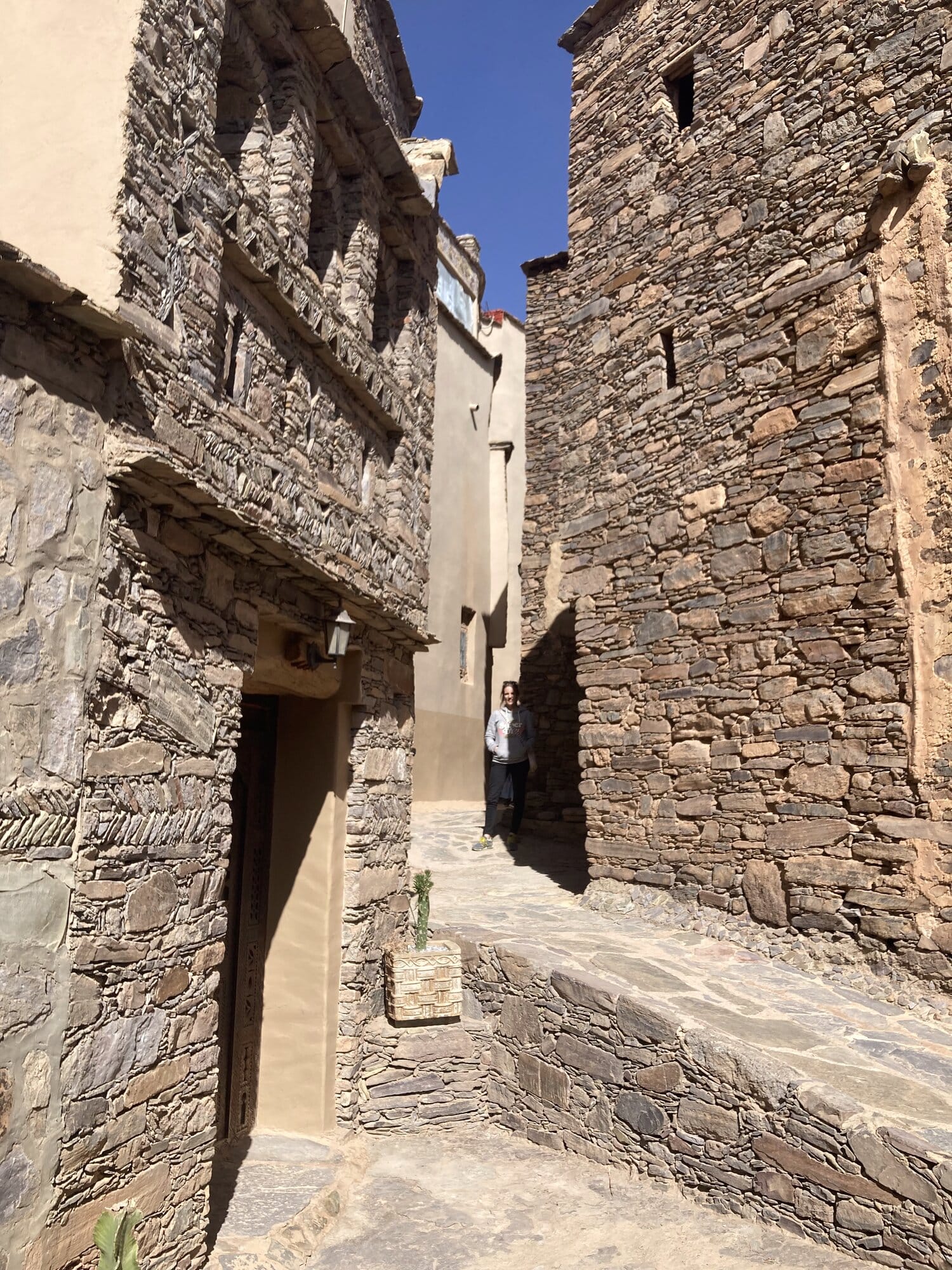 A narrow alley of drystone Berber houses in a hillside village in the Anti-Atlas — Tafraout region, Morocco