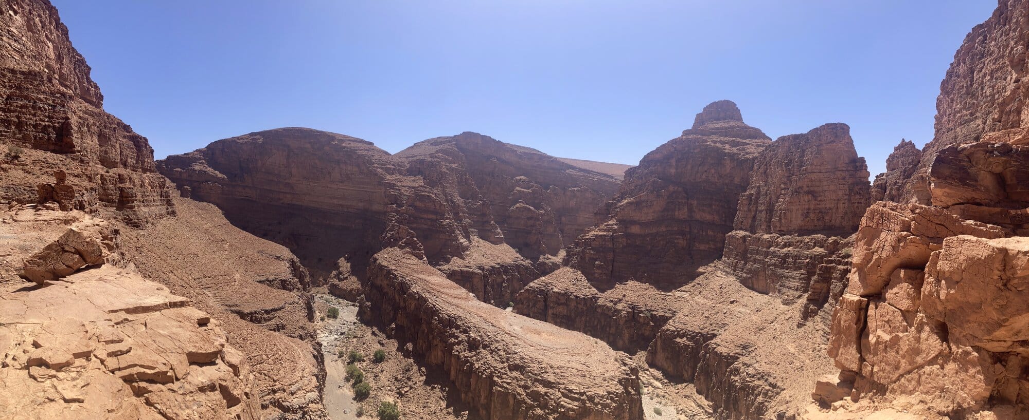 A panoramic view over the vast red-stratified canyons of the southern Anti-Atlas — Tarhjicht area, Morocco