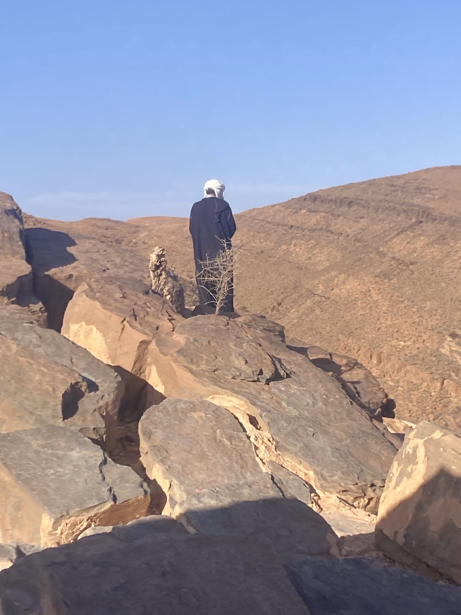 A towering natural rock spire rising above the ridge on the road south of Tafraout — Aït Mansour area, Morocco
