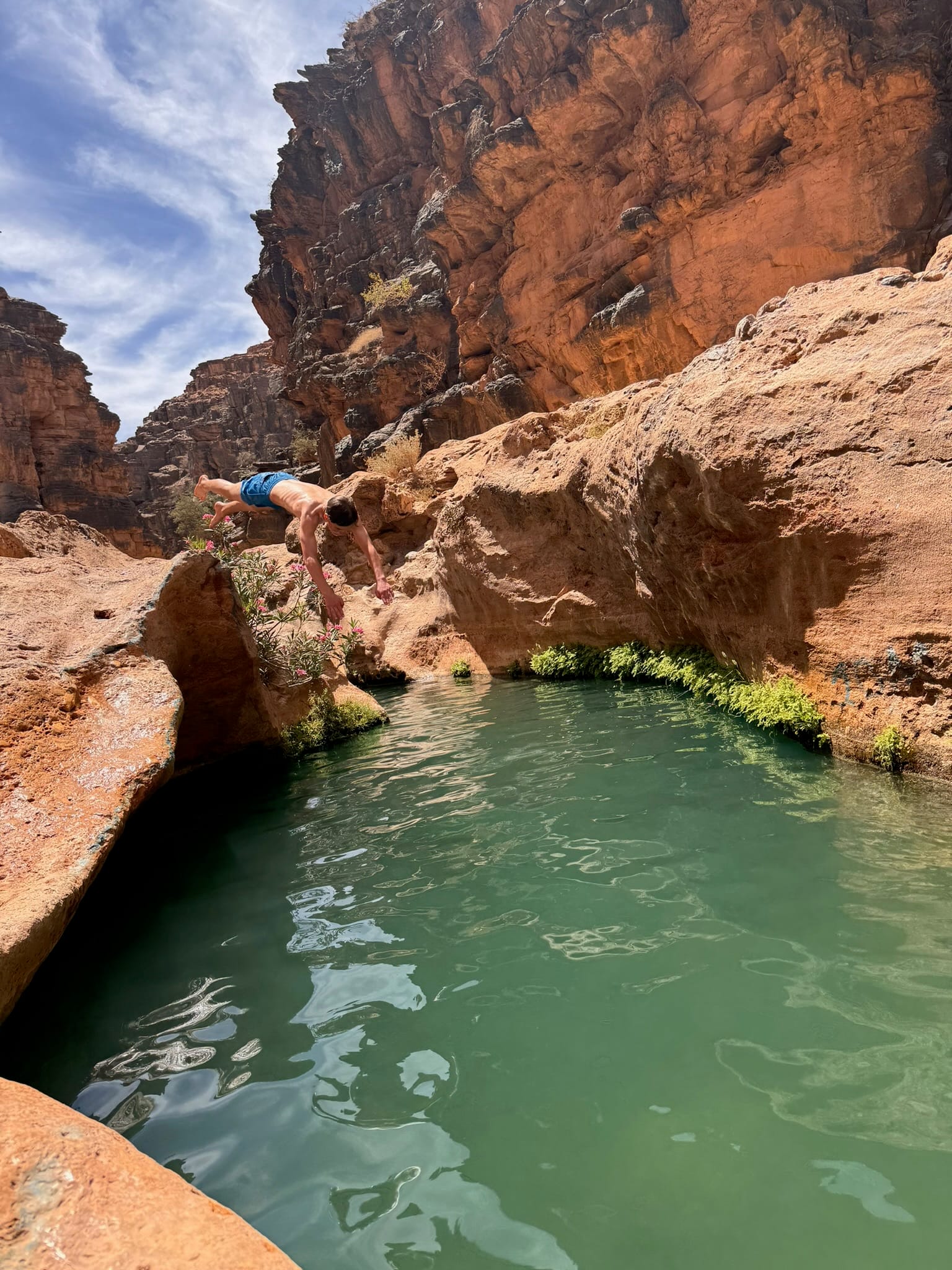 A long painted promenade in Sidi Ifni with murals on the walls and a figure walking in the distance — Sidi Ifni, Morocco