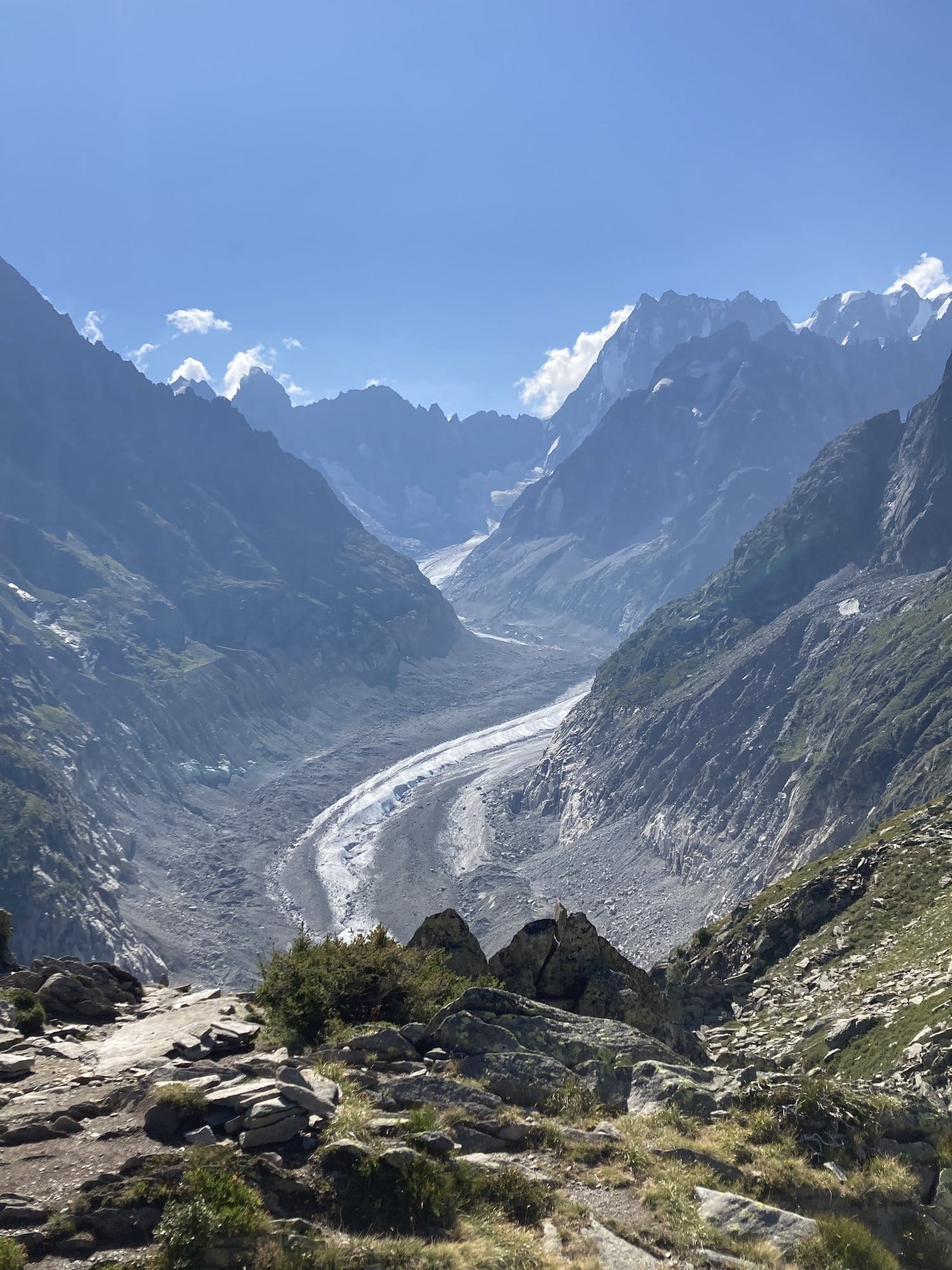 Panoramic view over the Mer de Glace glacier from the Montenvers viewpoint at 2,211m, showing the ice river winding between granite cliffs — Chamonix-Mont-Blanc, France