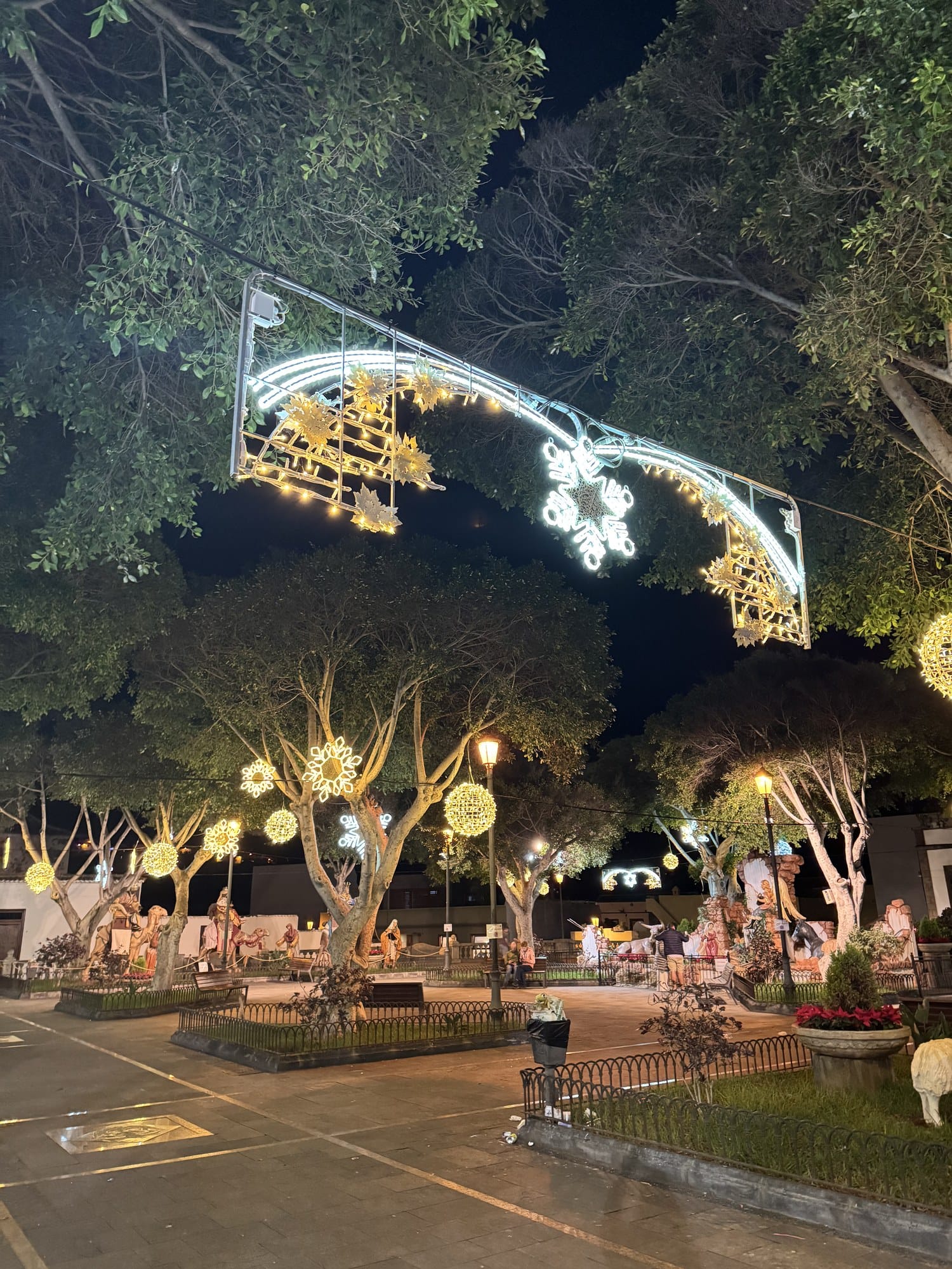 Una piazza del paese decorata per Capodanno con luci giganti a forma di fiocco di neve e un presepe in scala reale — nord di Tenerife