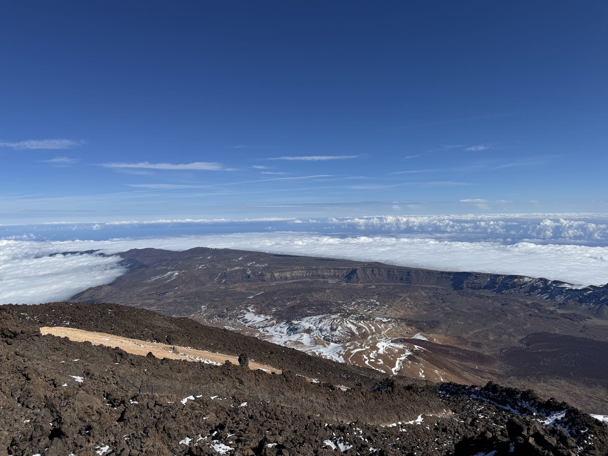 Looking down from near the summit of Teide at the volcanic caldera and a sea of low clouds — Teide National Park, Tenerife