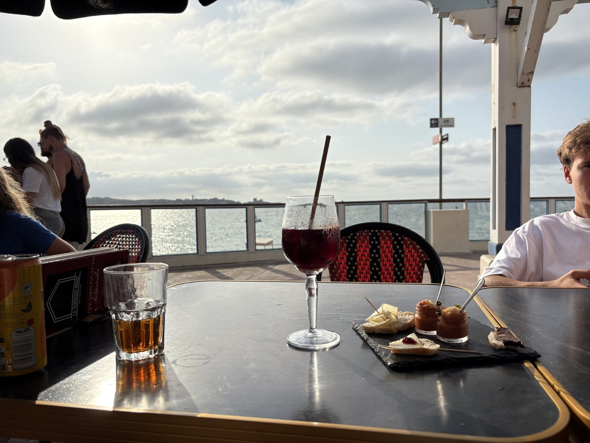 Evening drinks and tapas on a seafront terrace at Saint-Jean-de-Luz, with the Atlantic glittering in the background — French Basque Country