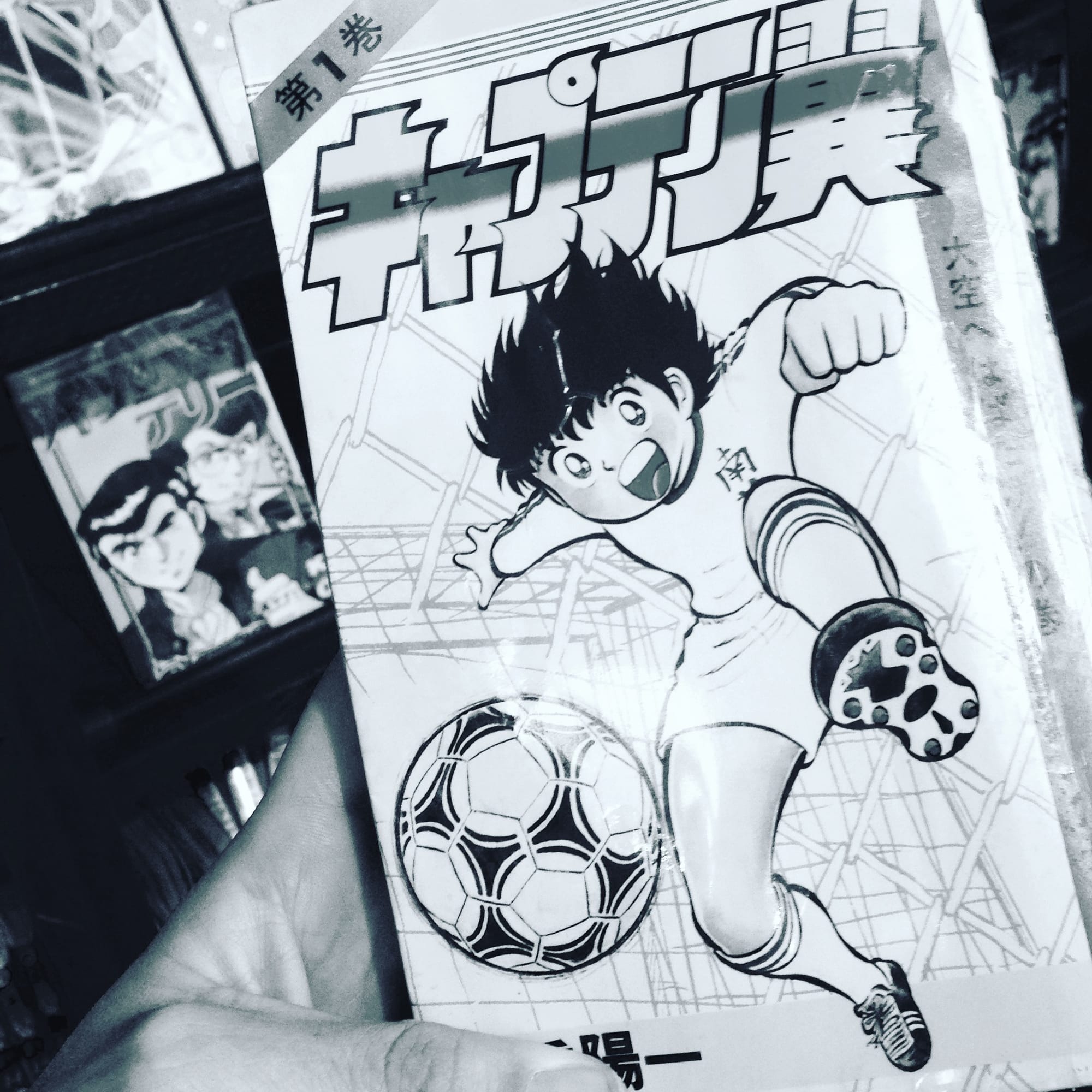 The first volume of Captain Tsubasa on a Kyoto arcade bookshop shelf — central Kyoto, Japan