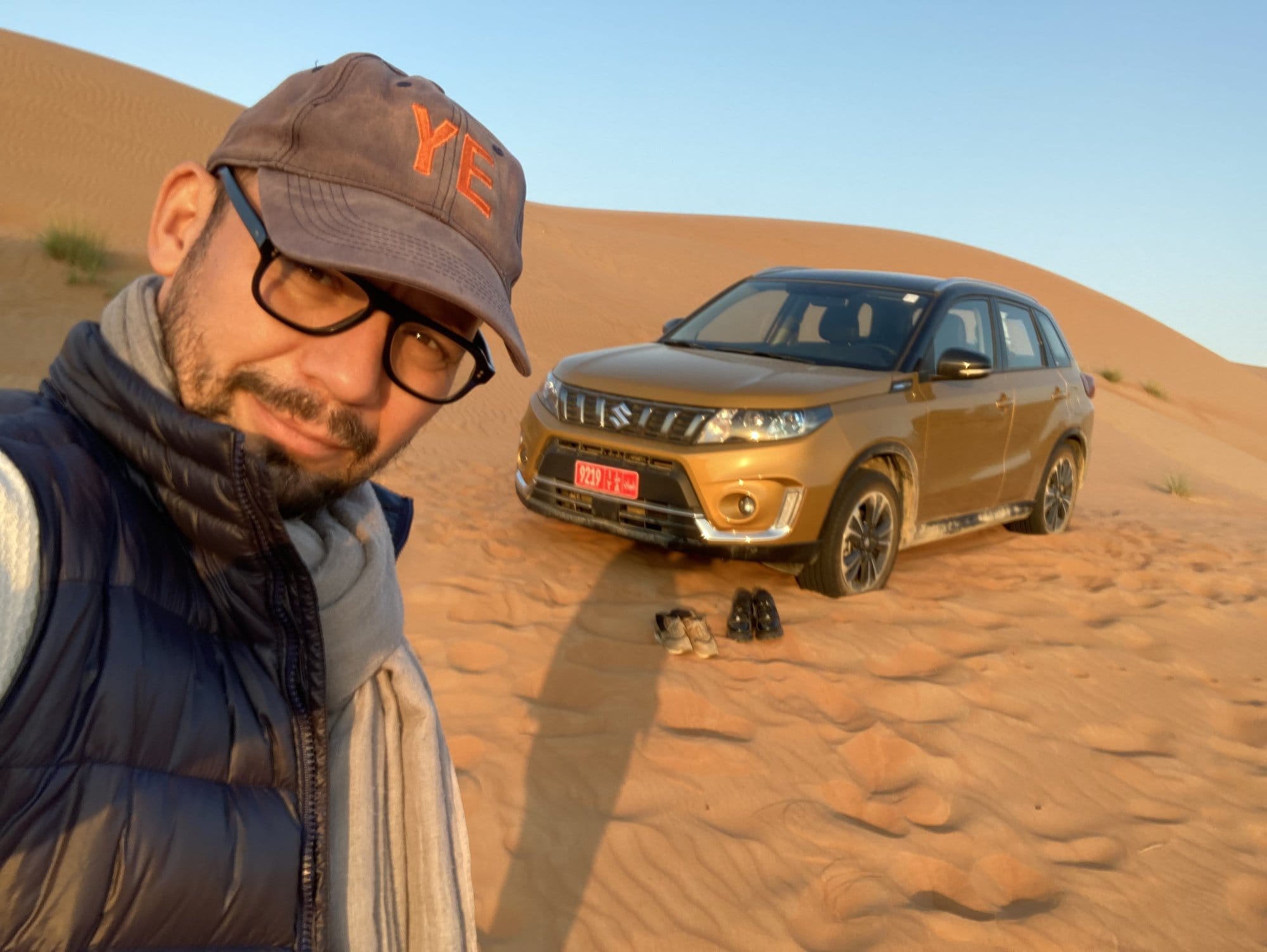 Selfie with the rental SUV stuck in the sand dunes, morning light โ Wahiba Sands, Oman
