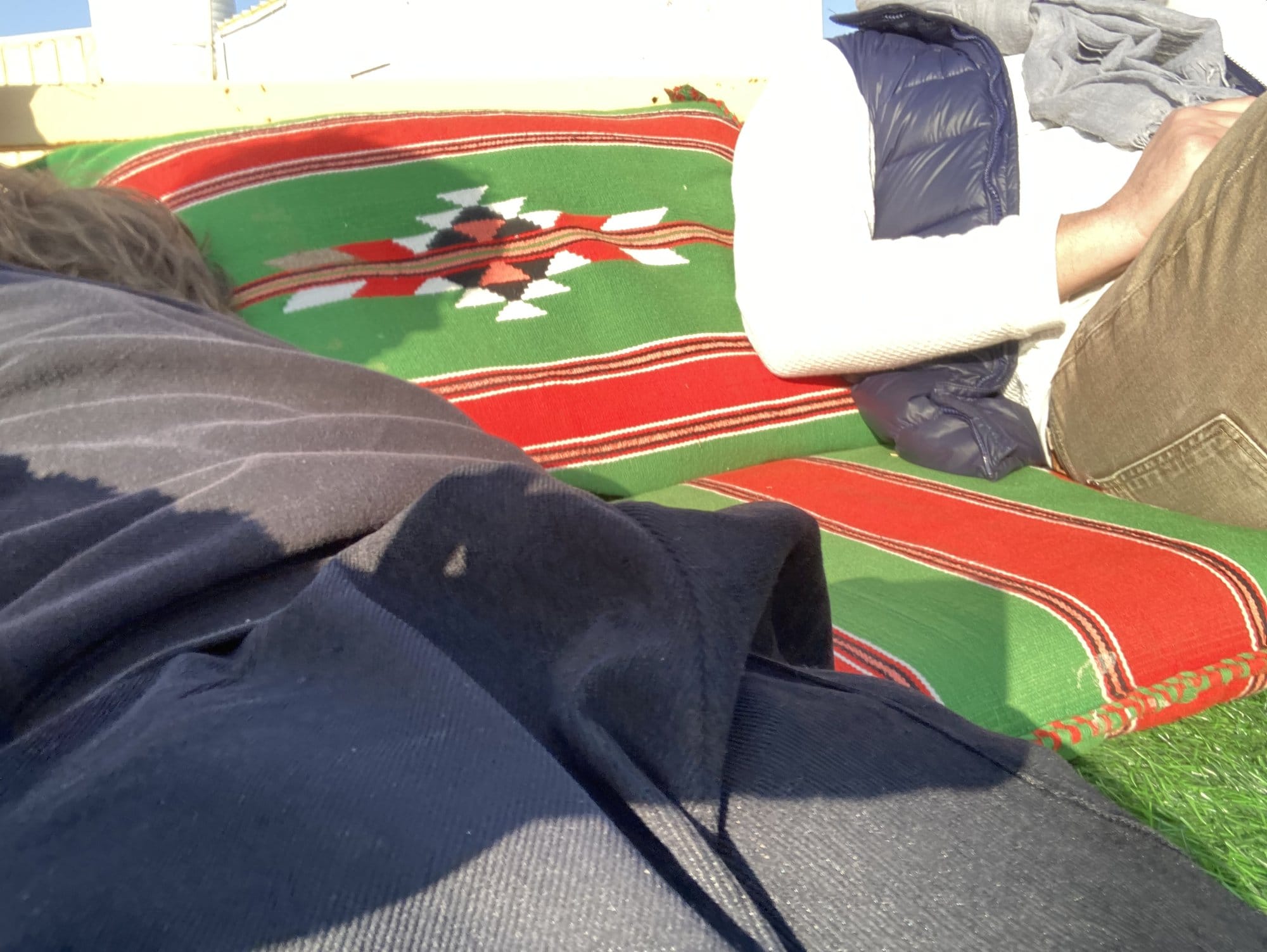 Traditional Bedouin textiles and cushions in the desert camp lounge area โ Wahiba Sands, Oman