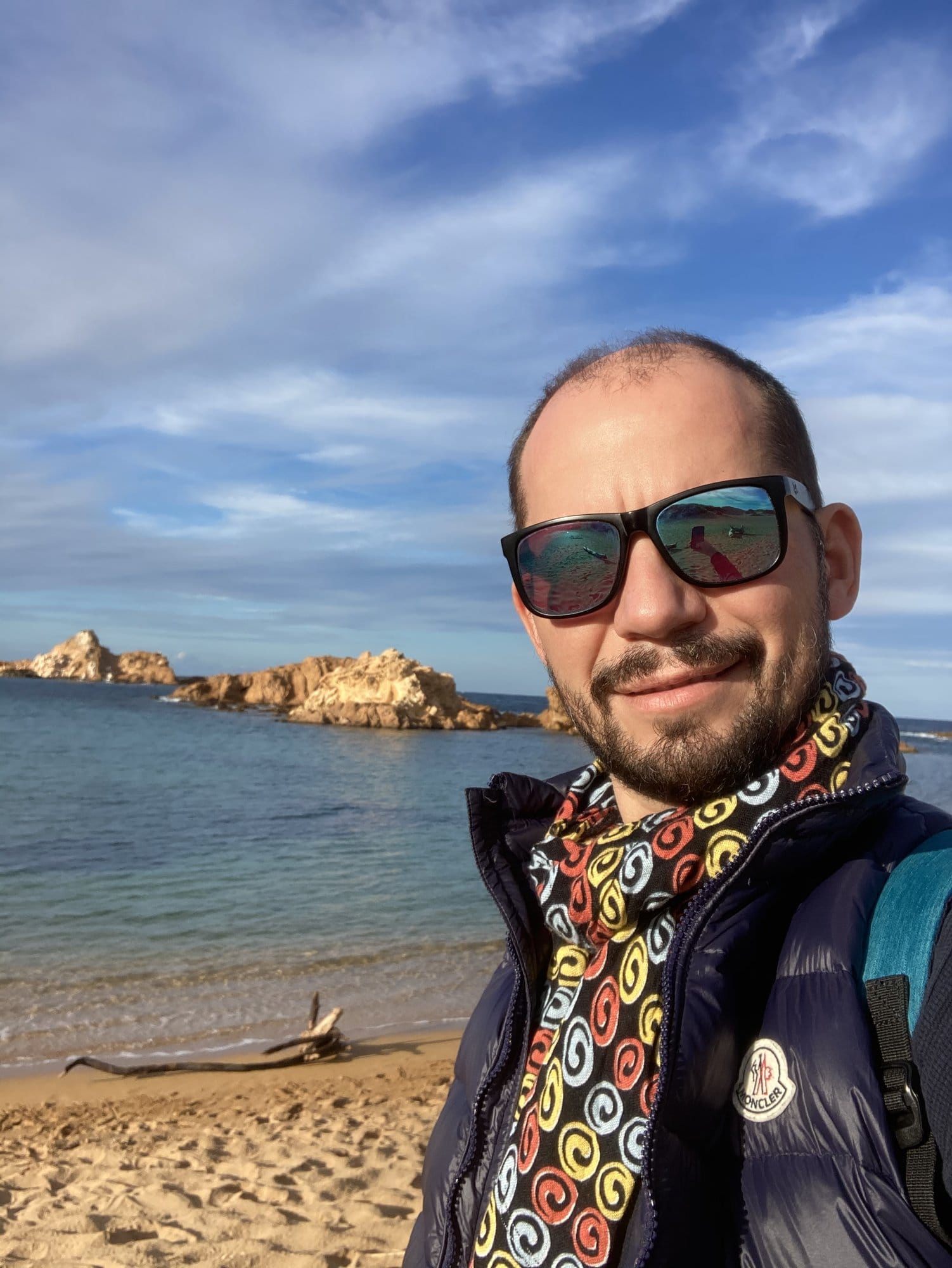 Children wading in turquoise water at a shallow cove — Menorca, Spain