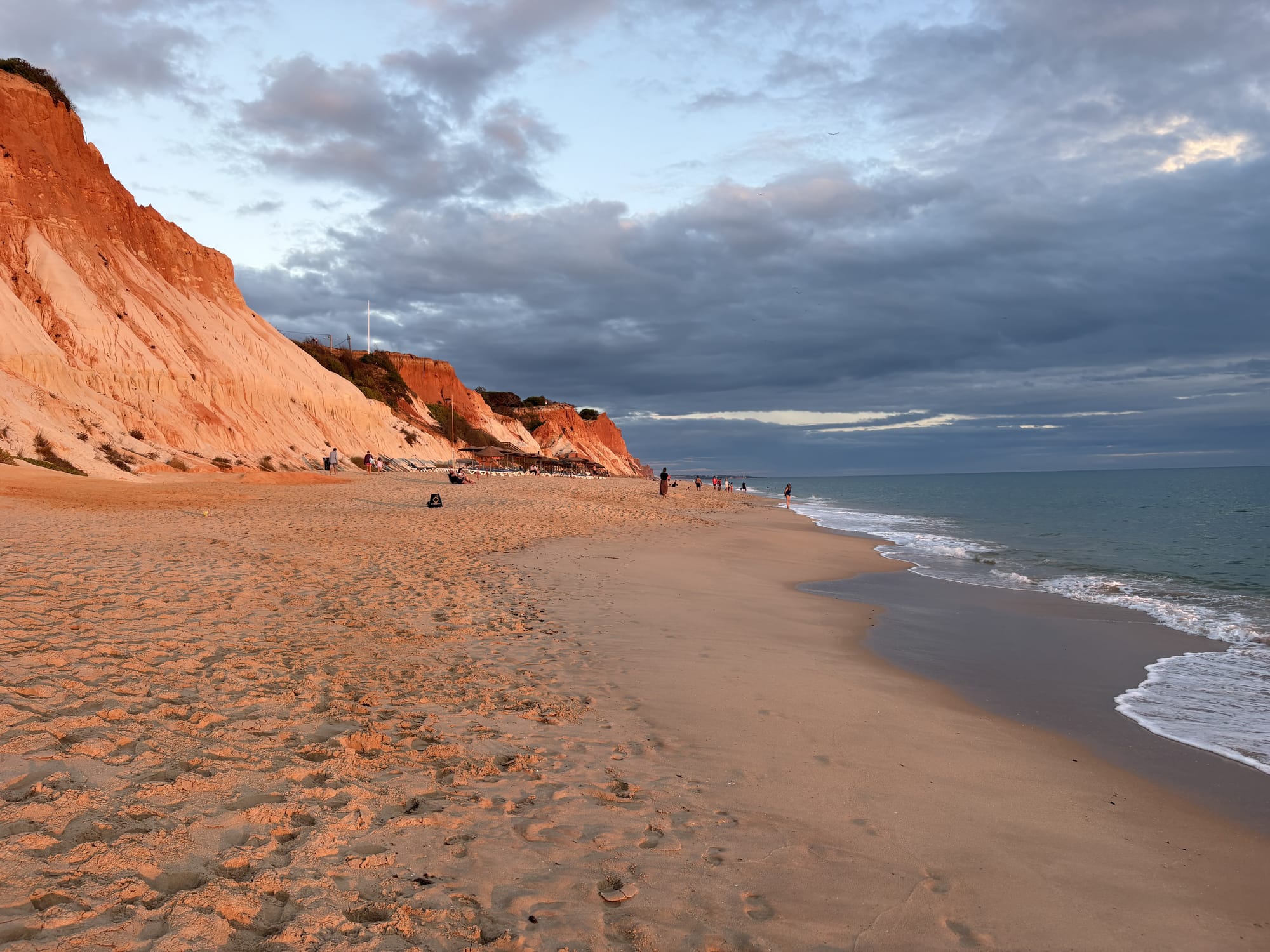 Dramatic red sandstone cliffs backing a wide sandy beach — Praia da Falésia, Algarve