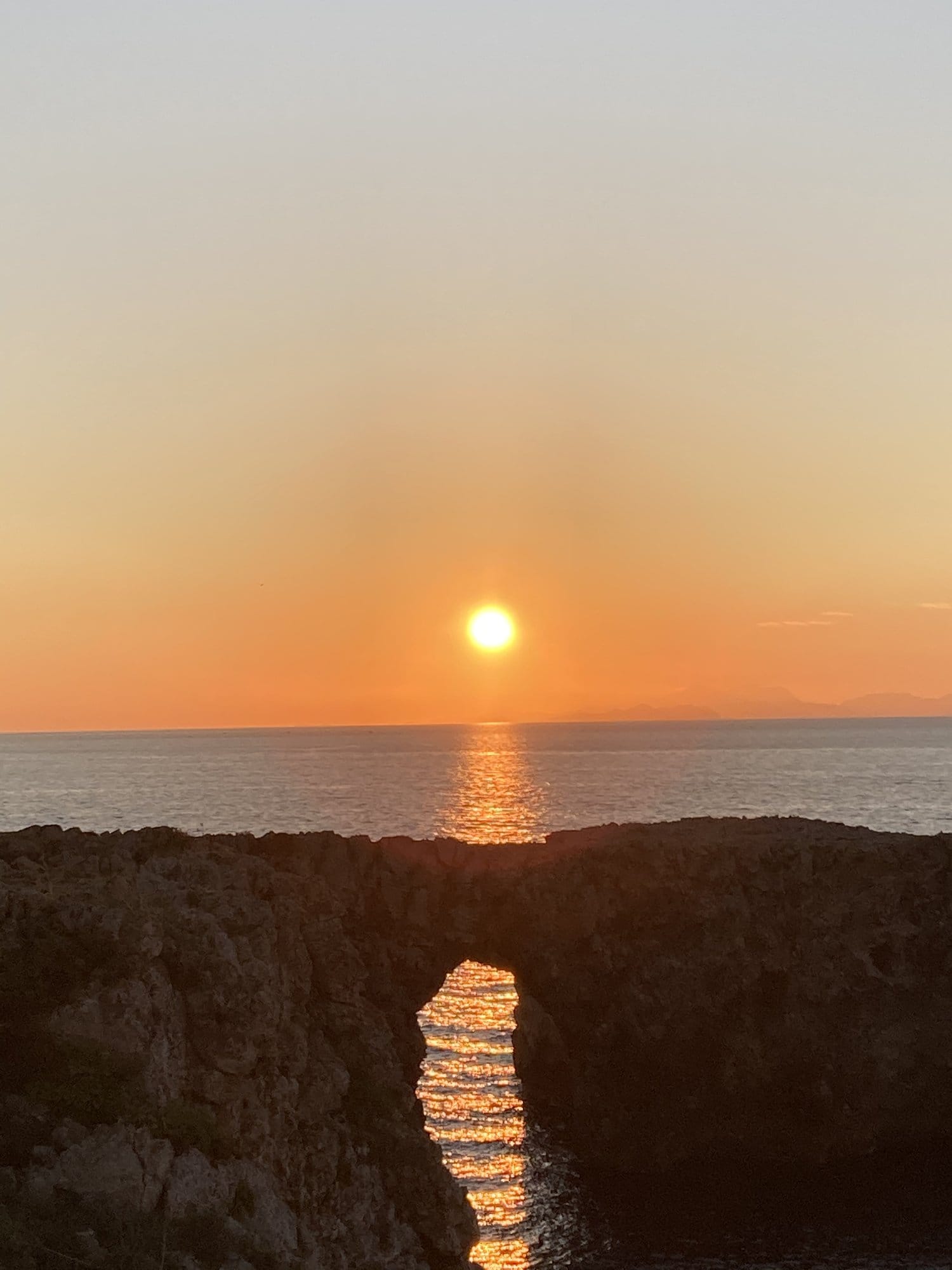Sunset through stone archway — Ciutadella, Spain