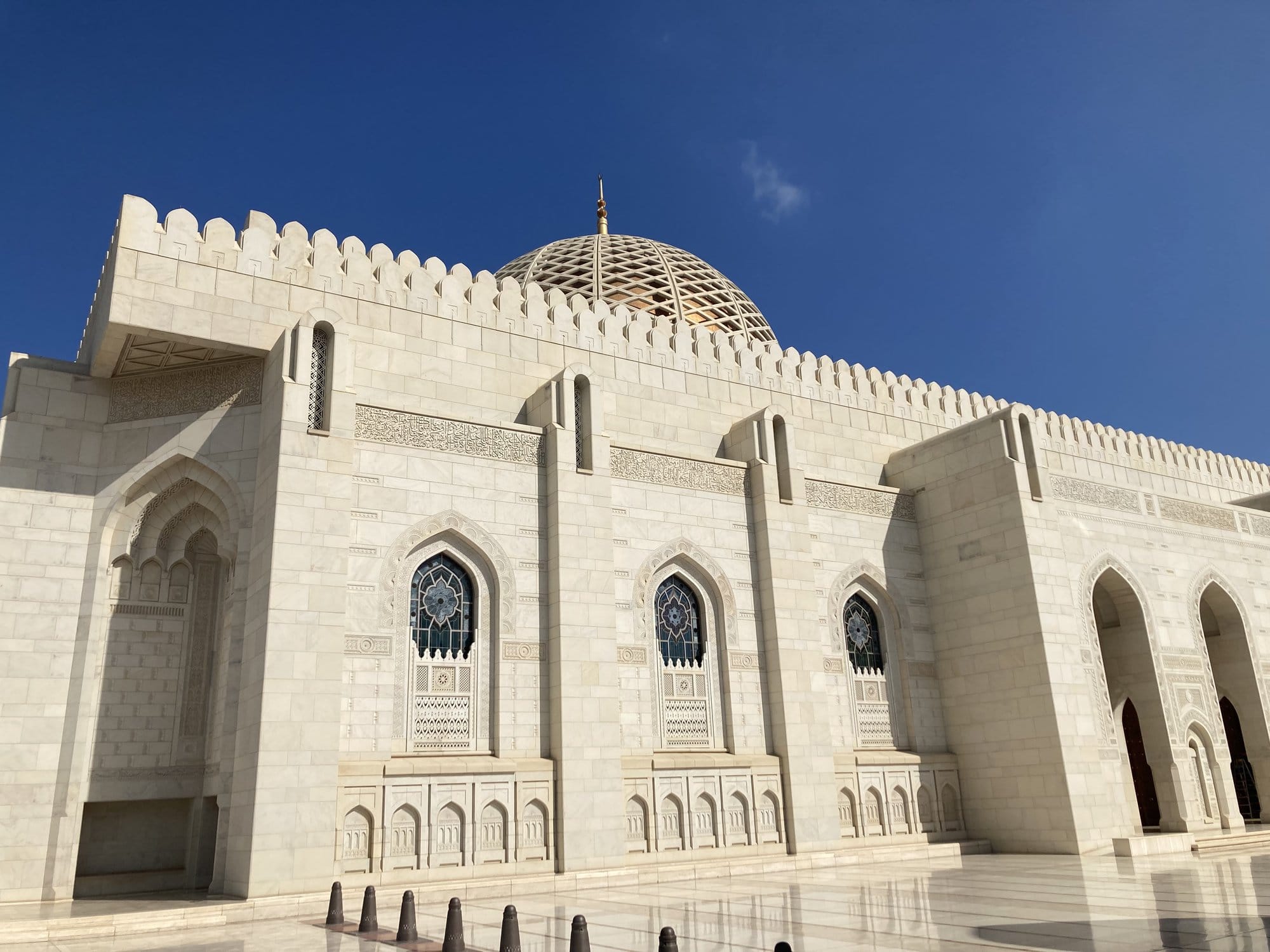 The white marble façade and golden dome of the Sultan Qaboos Grand Mosque — Bawshar, Oman