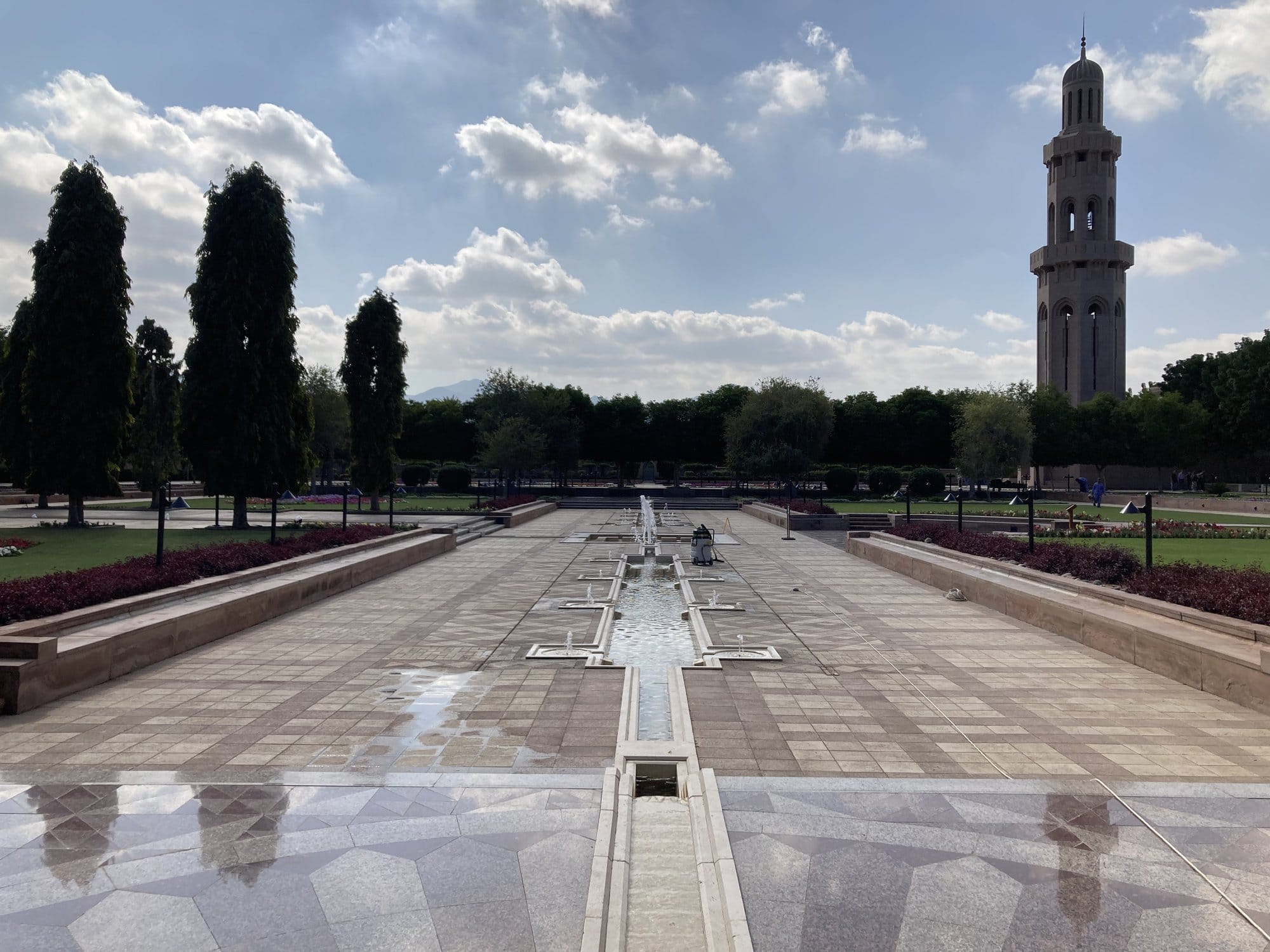The formal gardens and fountain walkway of the Grand Mosque with the minaret in the background — Bawshar, Oman
