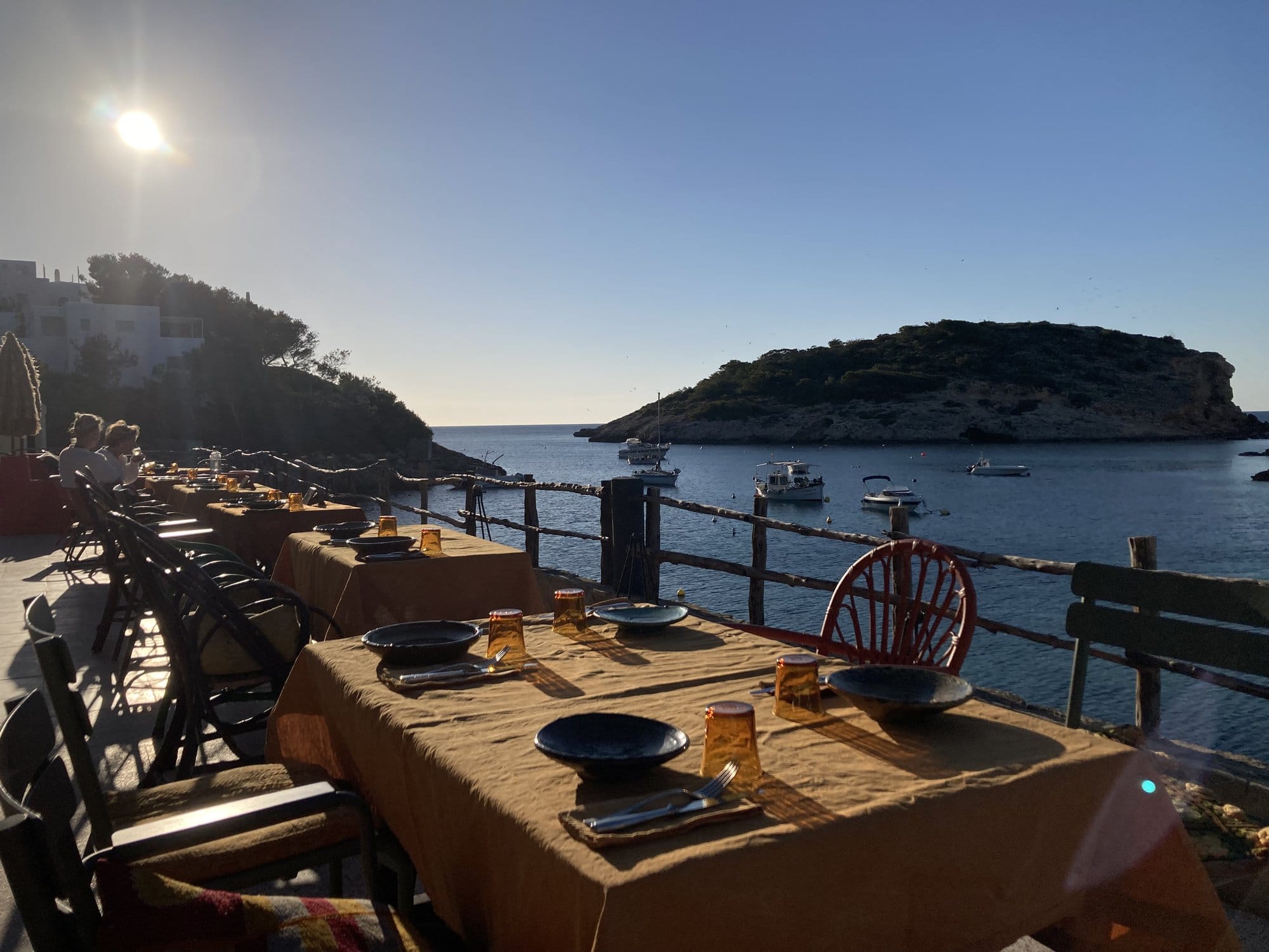 Beachfront terrace dining with boats in bay — Ibiza, Spain