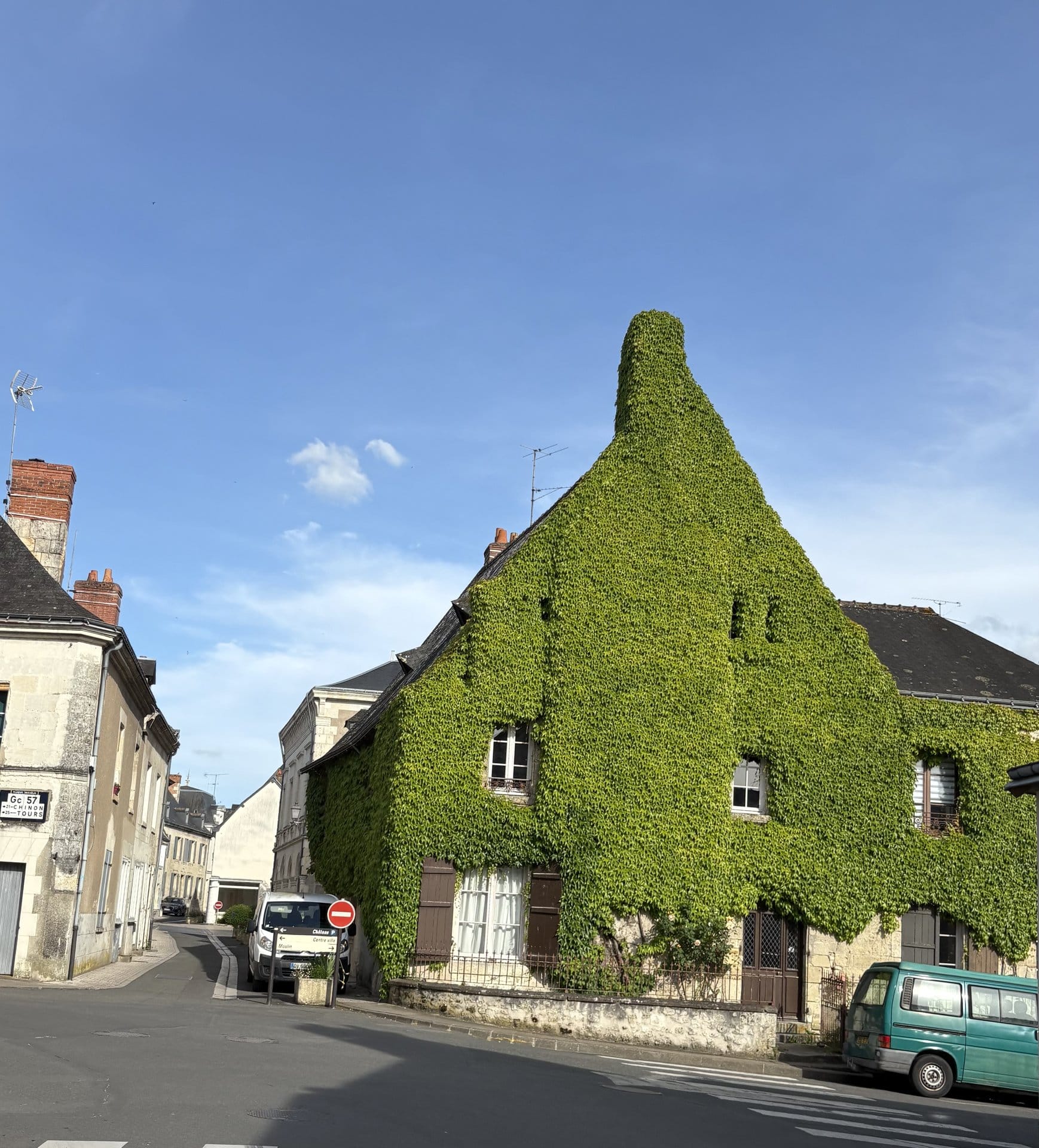 A house on Avenue Adélaïde Riché completely covered in bright green ivy, with shuttered windows and an old green van parked outside — Azay-le-Rideau