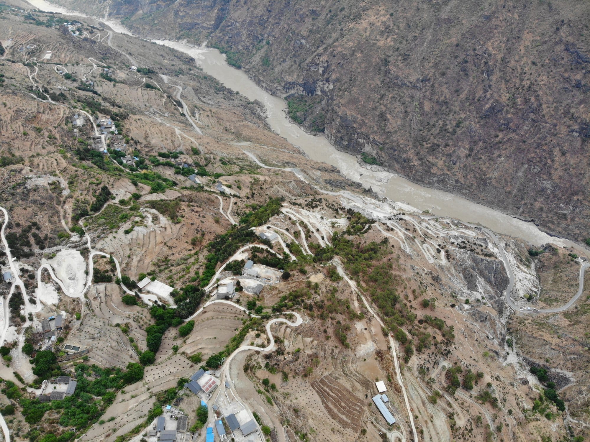 The switchbacks and terraced plots above the river, seen from the air.