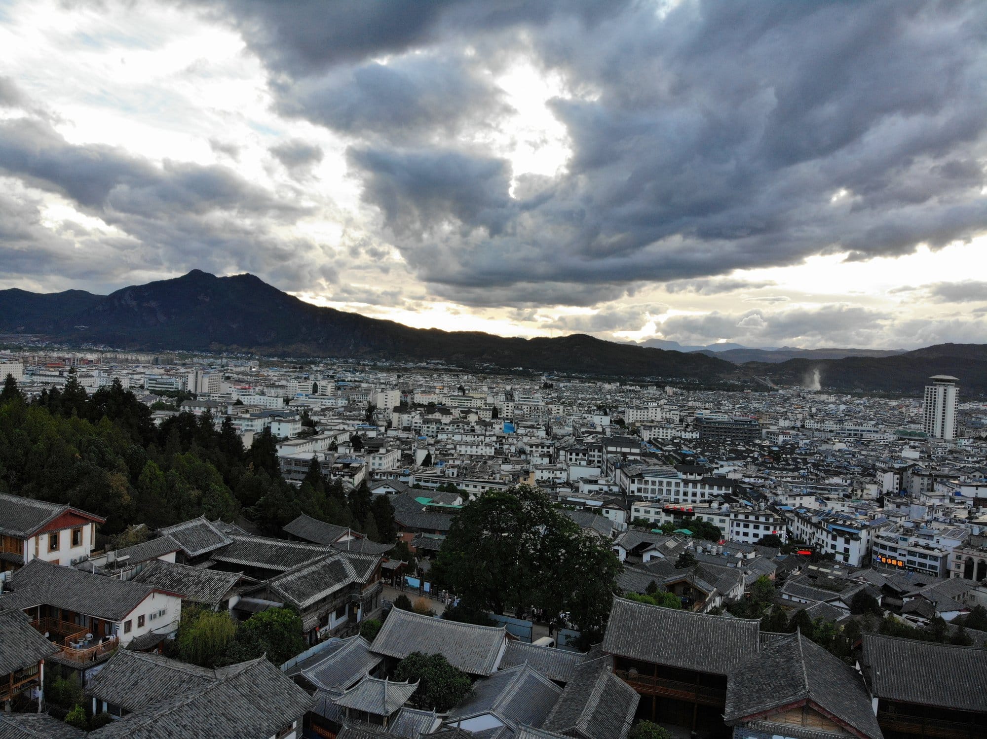 The roofs of the old town at dusk, the new town and the hills beyond.