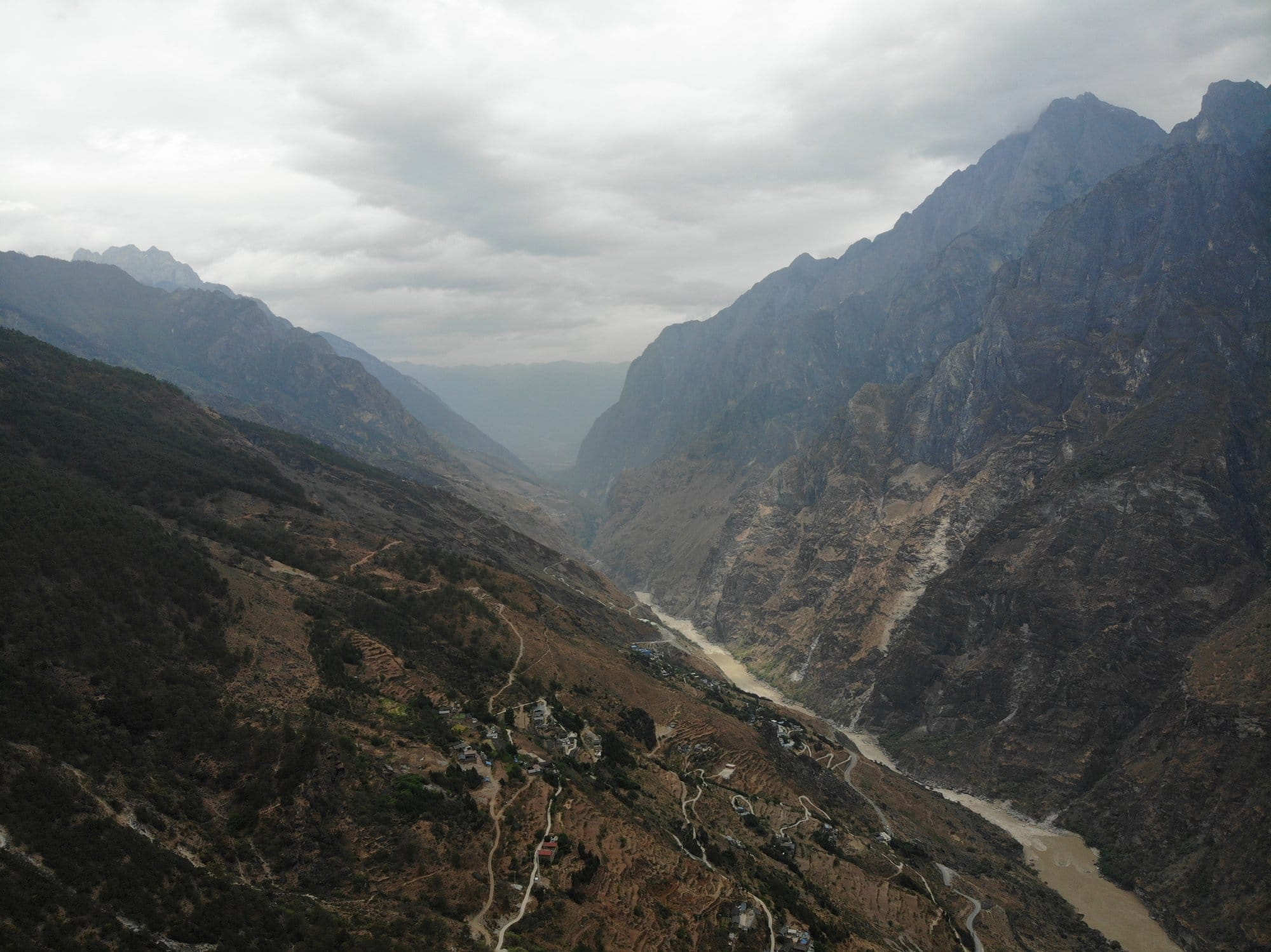 The gorge from the air, the trail cut into the flank above the river.