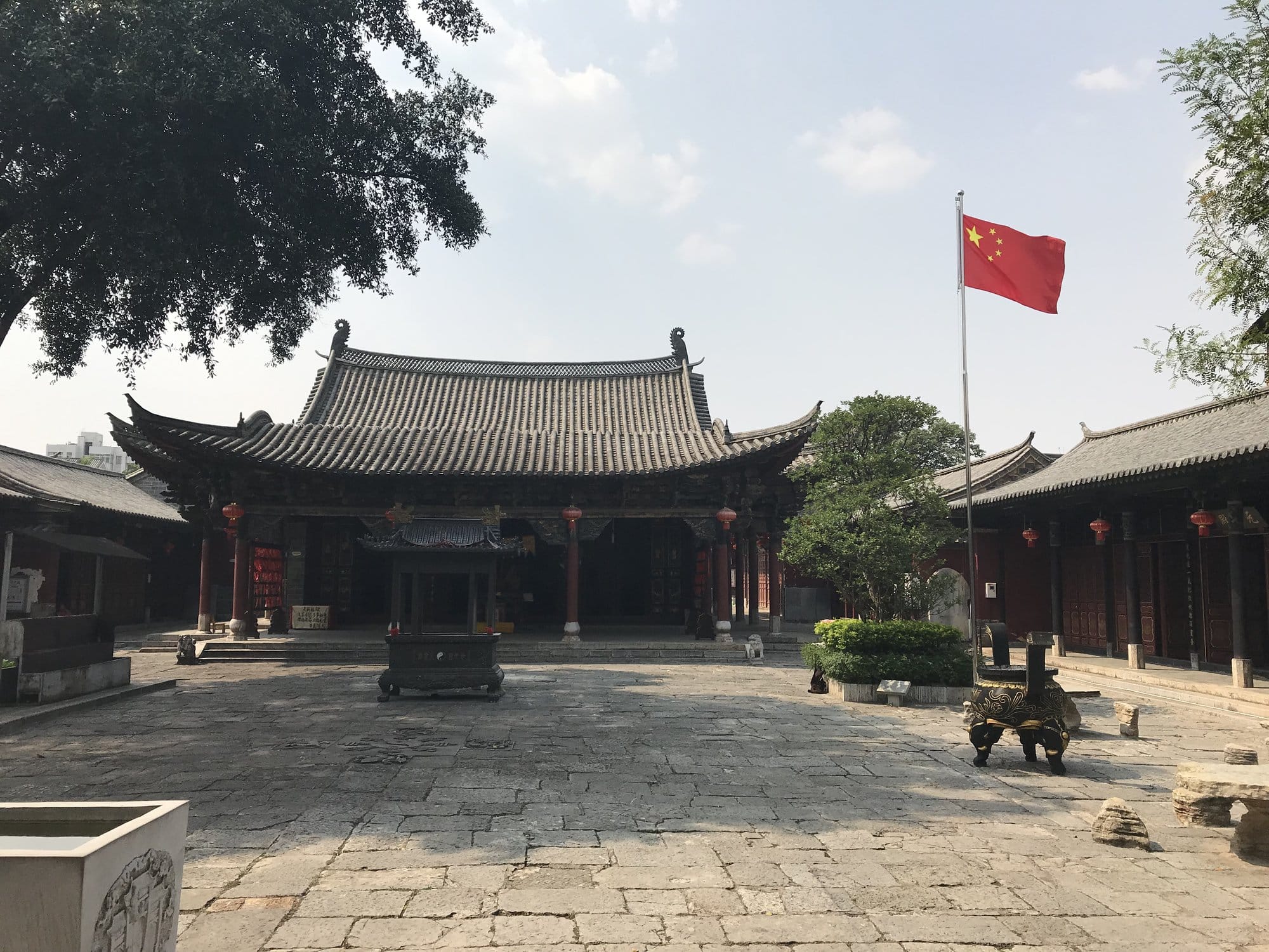 A temple courtyard in the old town, bronze incense burner in the centre.