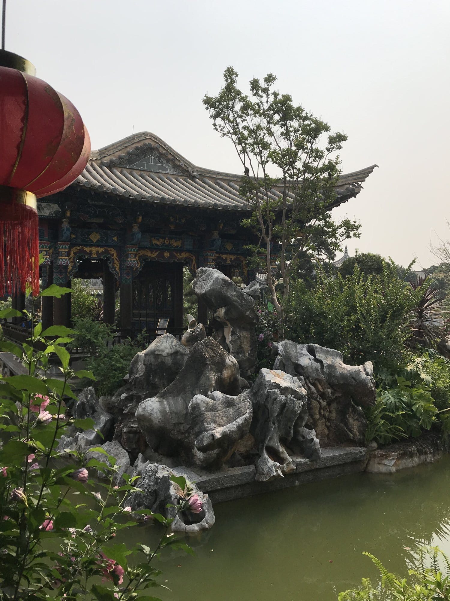 A pond pavilion in the Zhu Family Garden, rockery and lantern in the foreground.