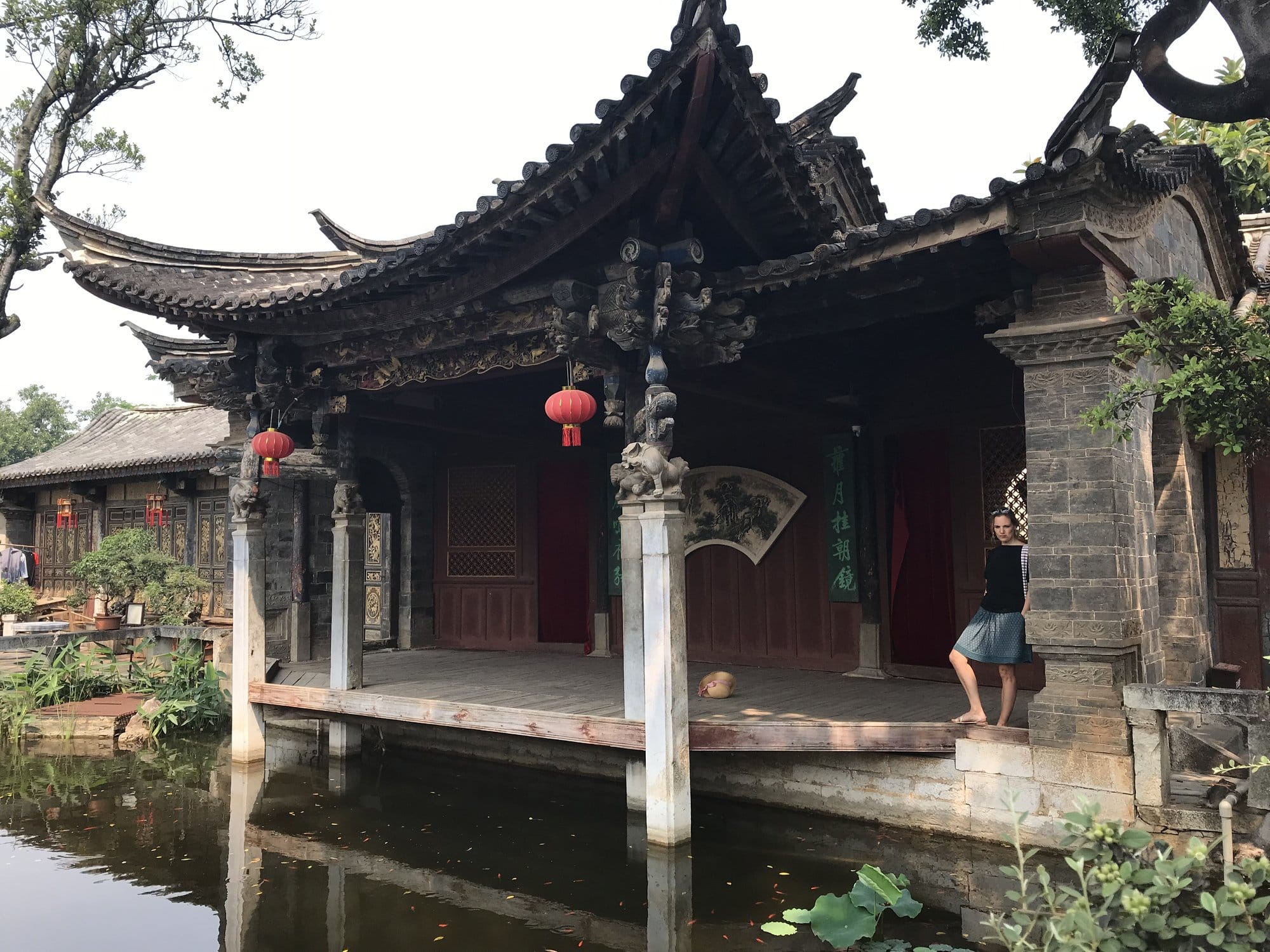 A pavilion built out over the garden pond.