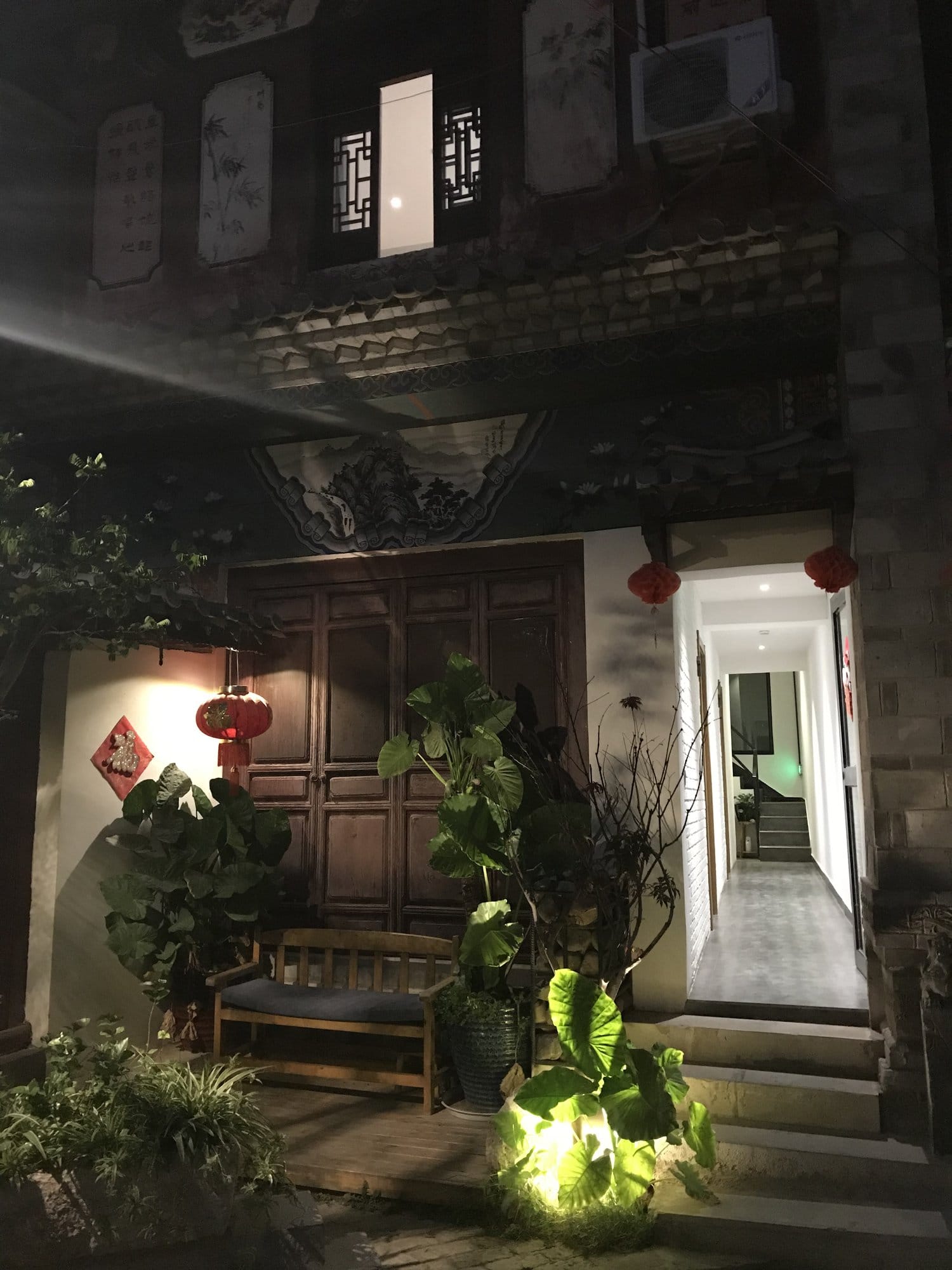 The courtyard of a restored guesthouse in the old town at night.