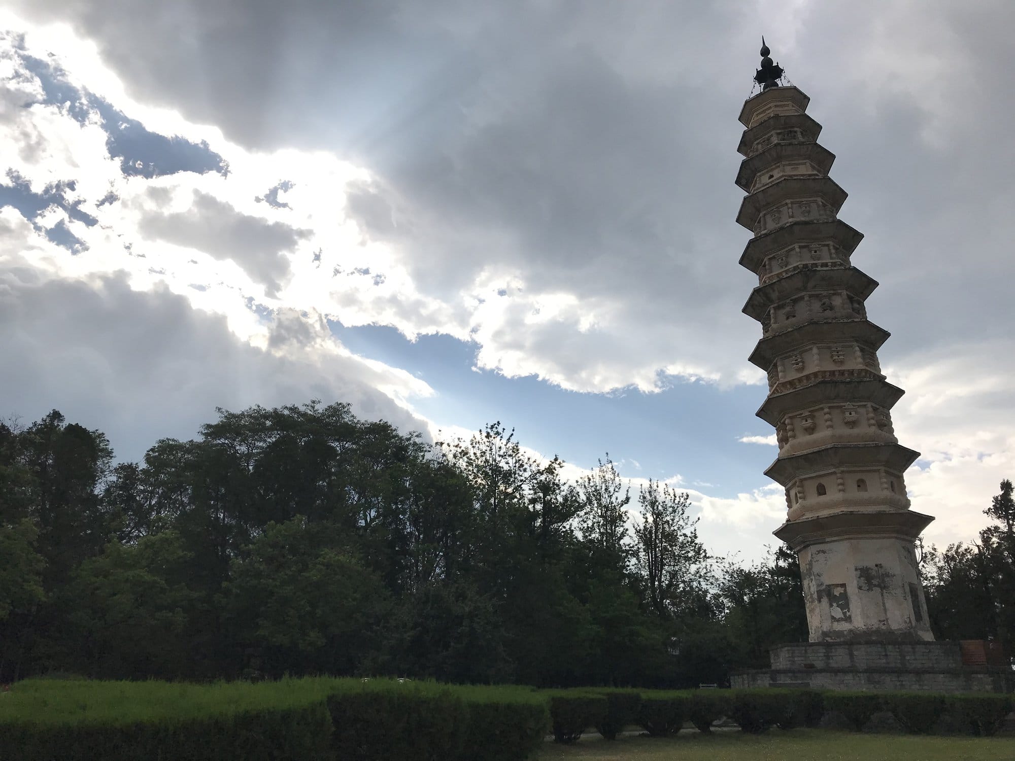 One of the two flanking pagodas in silhouette against an evening sky.