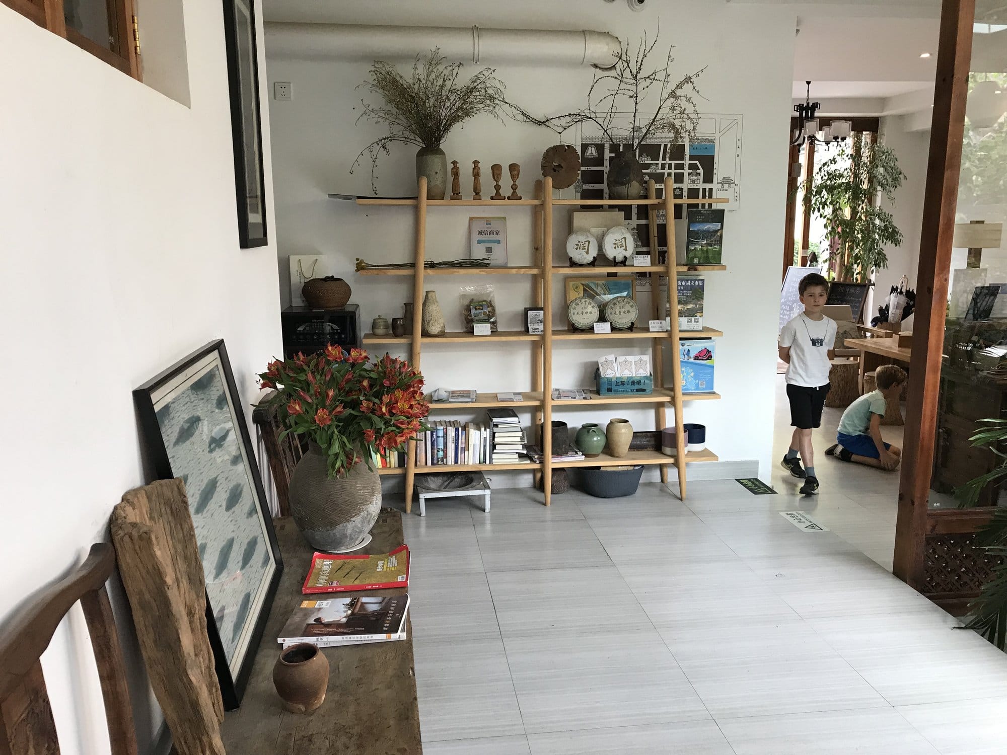 The interior of a courtyard inn in Dali old town, shelves of local ceramics.