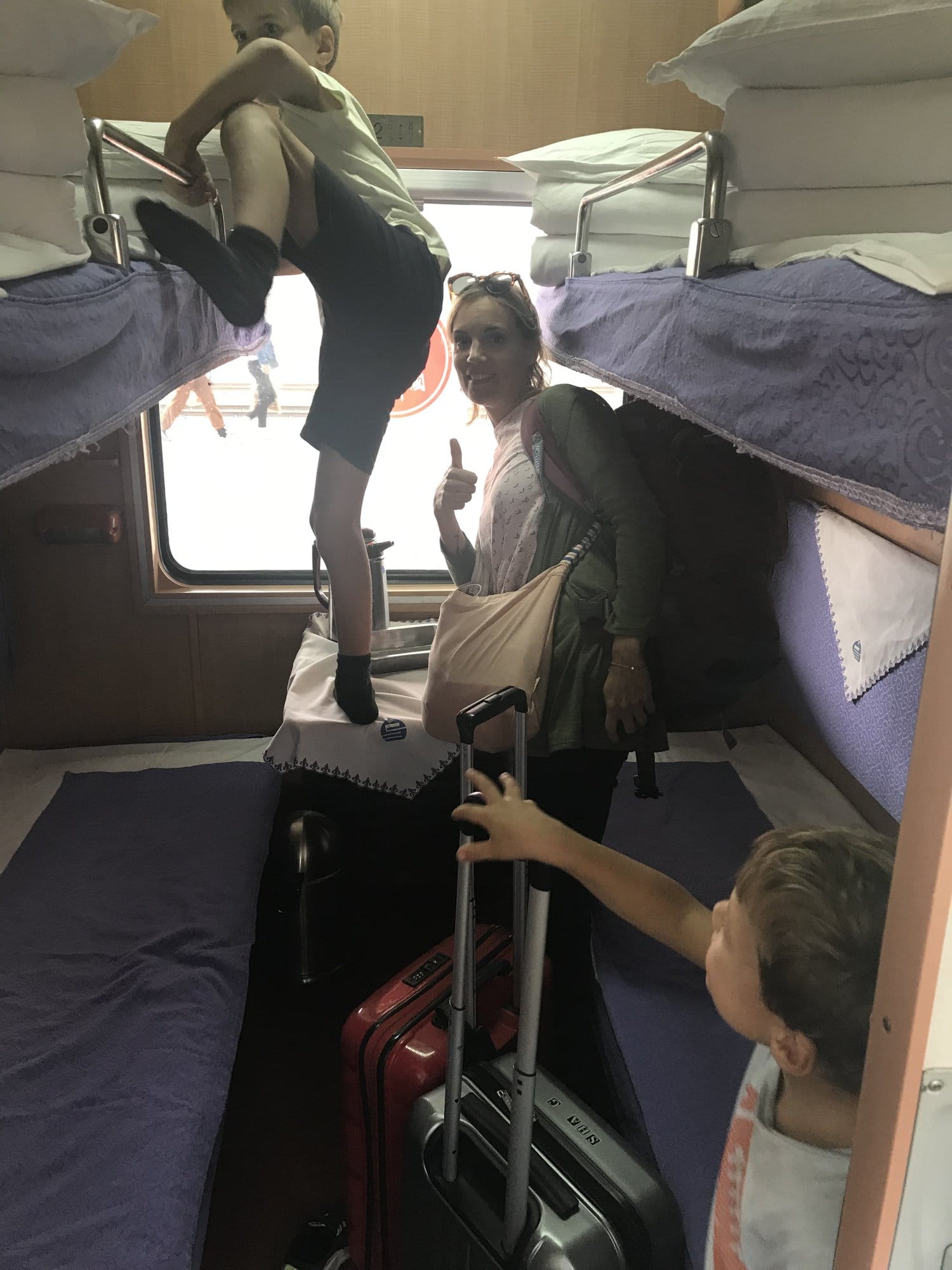 A sleeper compartment on the overnight train west, cases stowed on the floor.